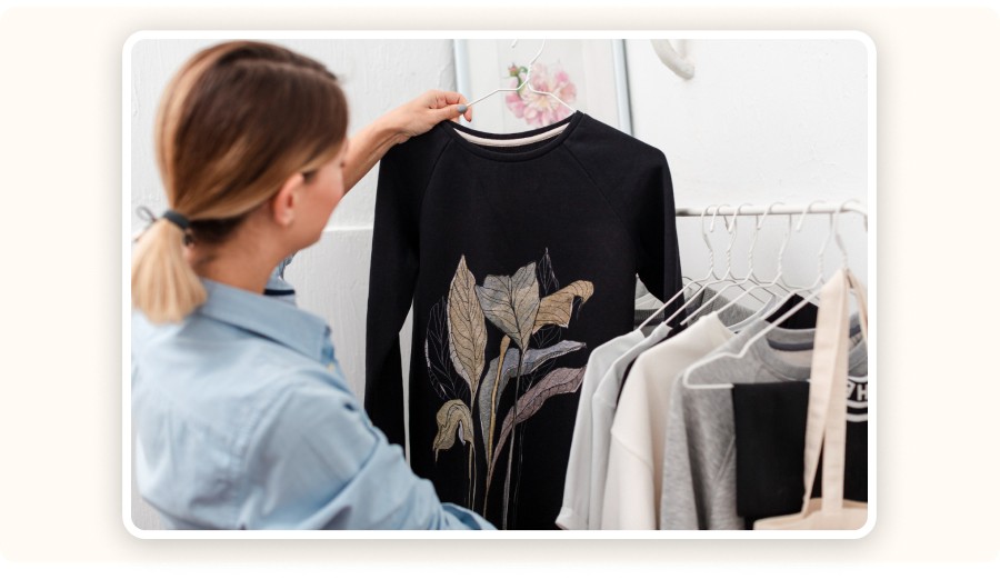 A woman holding a custom sweatshirt