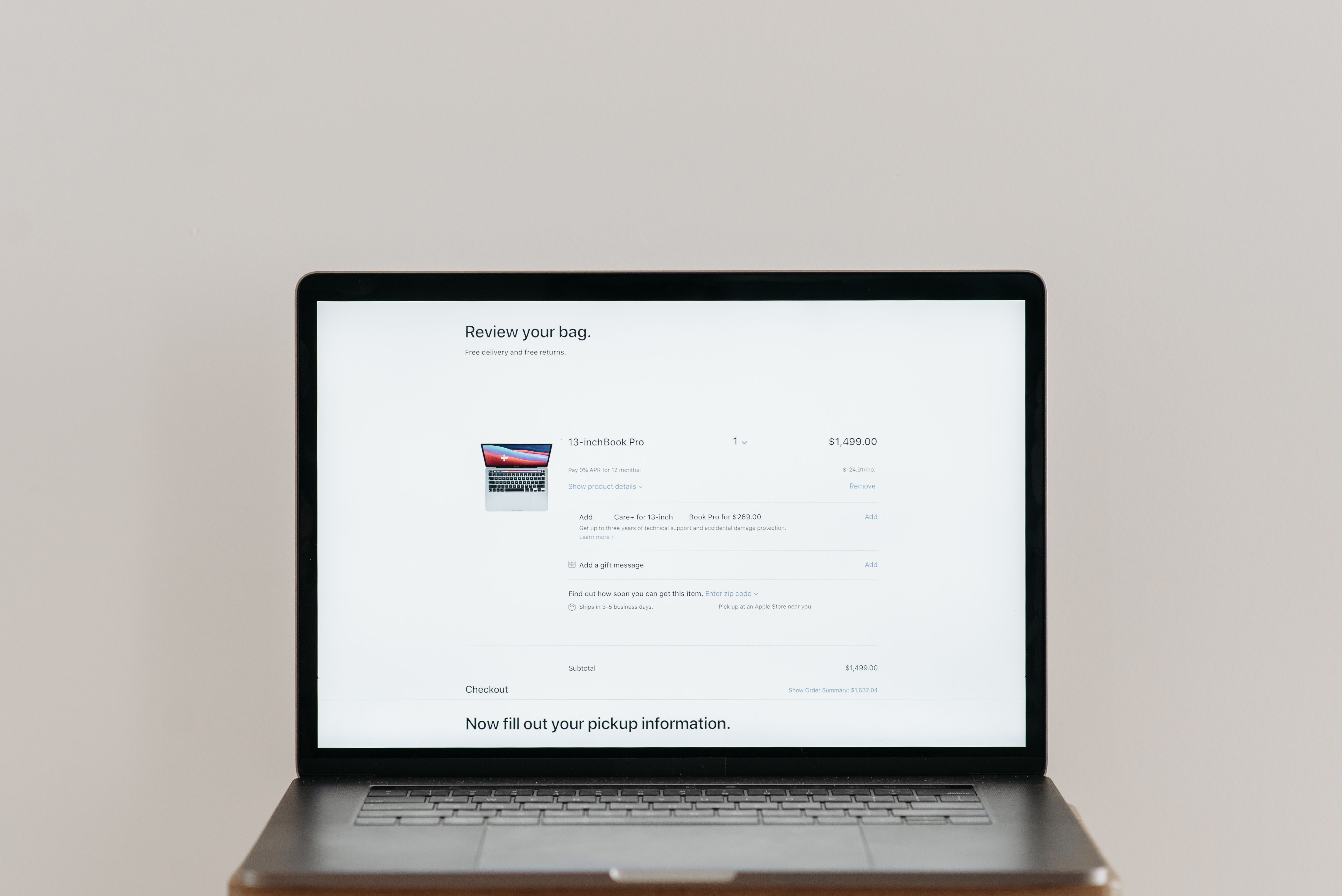 Minimalist laptop showing an online checkout screen on a white background, ideal for tech context.