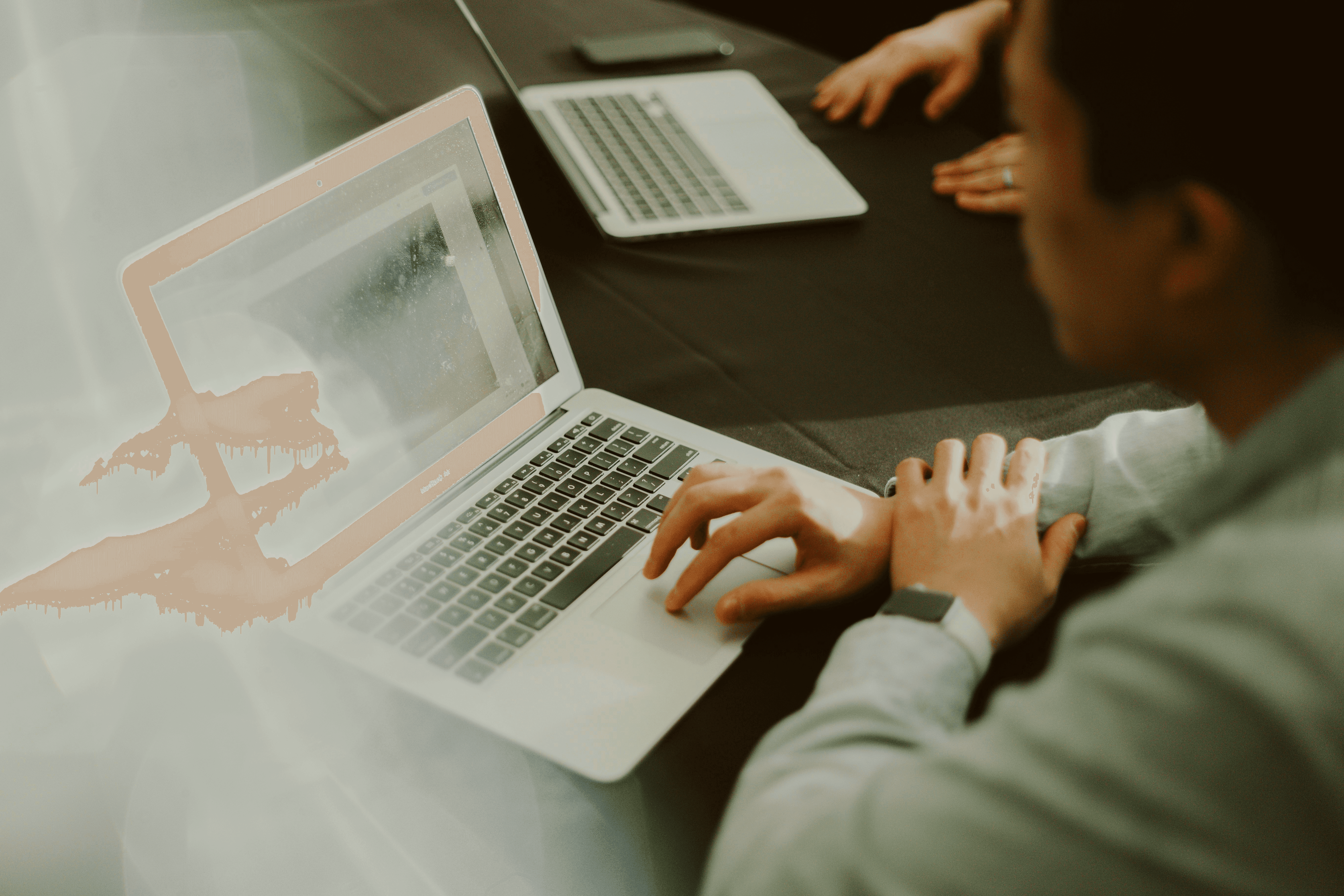 a man sitting in front of a laptop computer