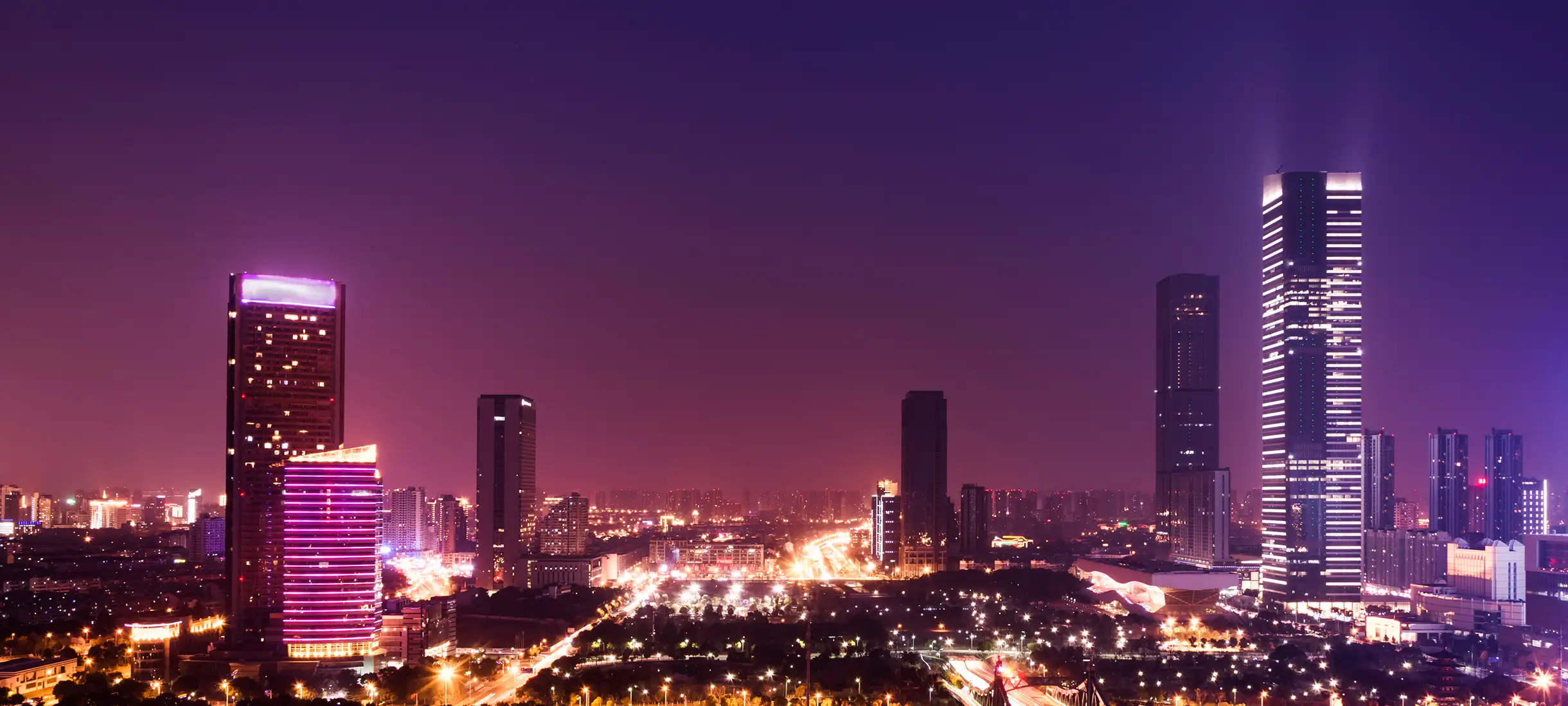 Nighttime Dubai skyline with illuminated buildings and urban setting