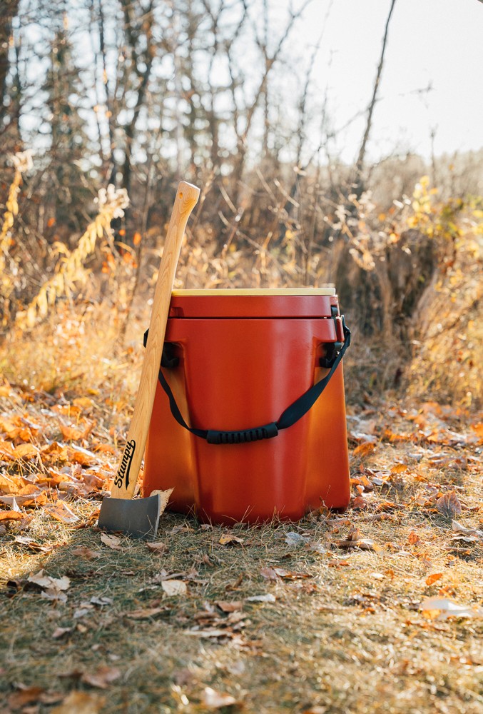 a axe leans on a wood chopping block 