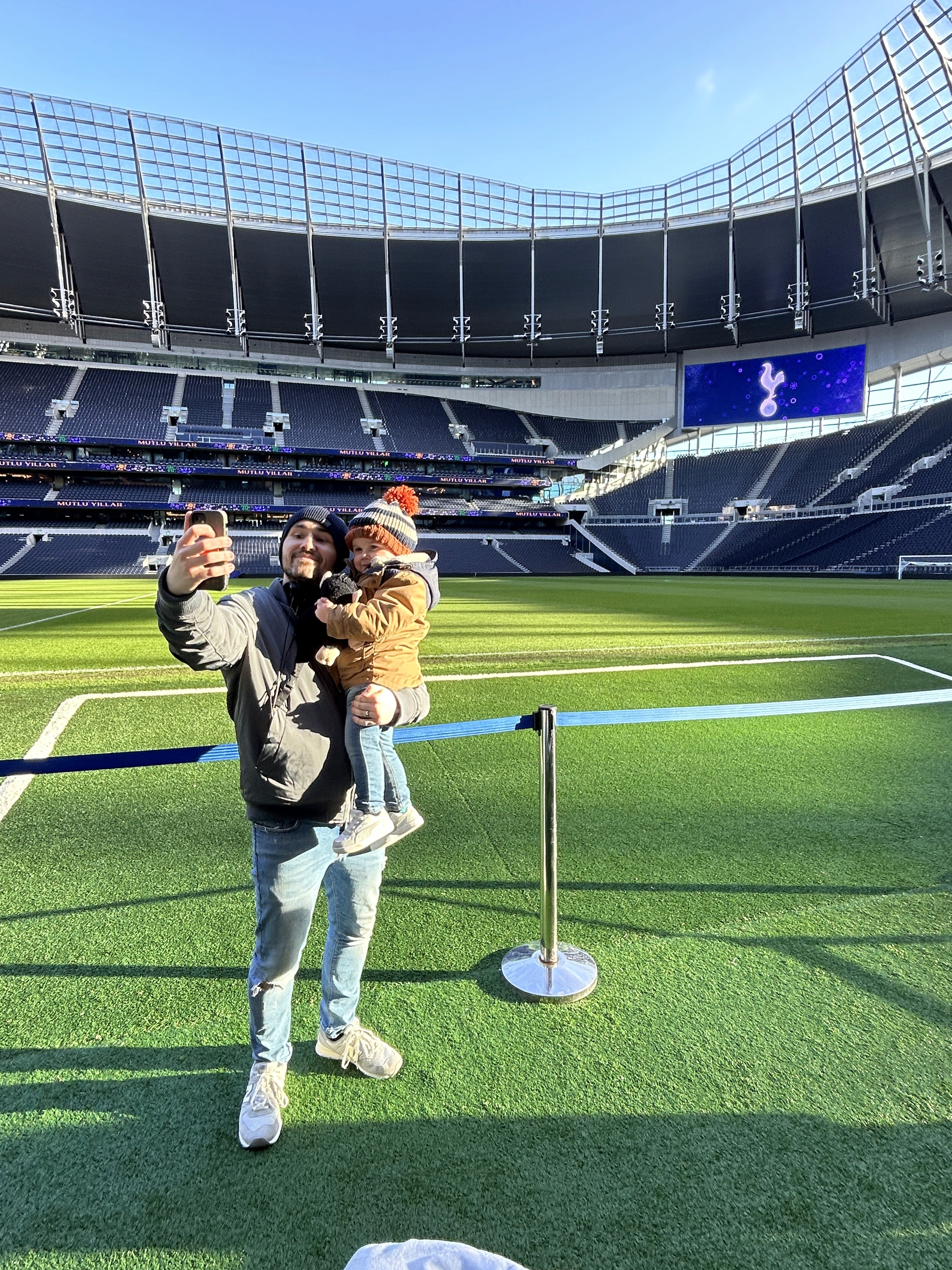 Picture of Adrian taking a selfie with his son at the Tottenham Hotspur stadium.
