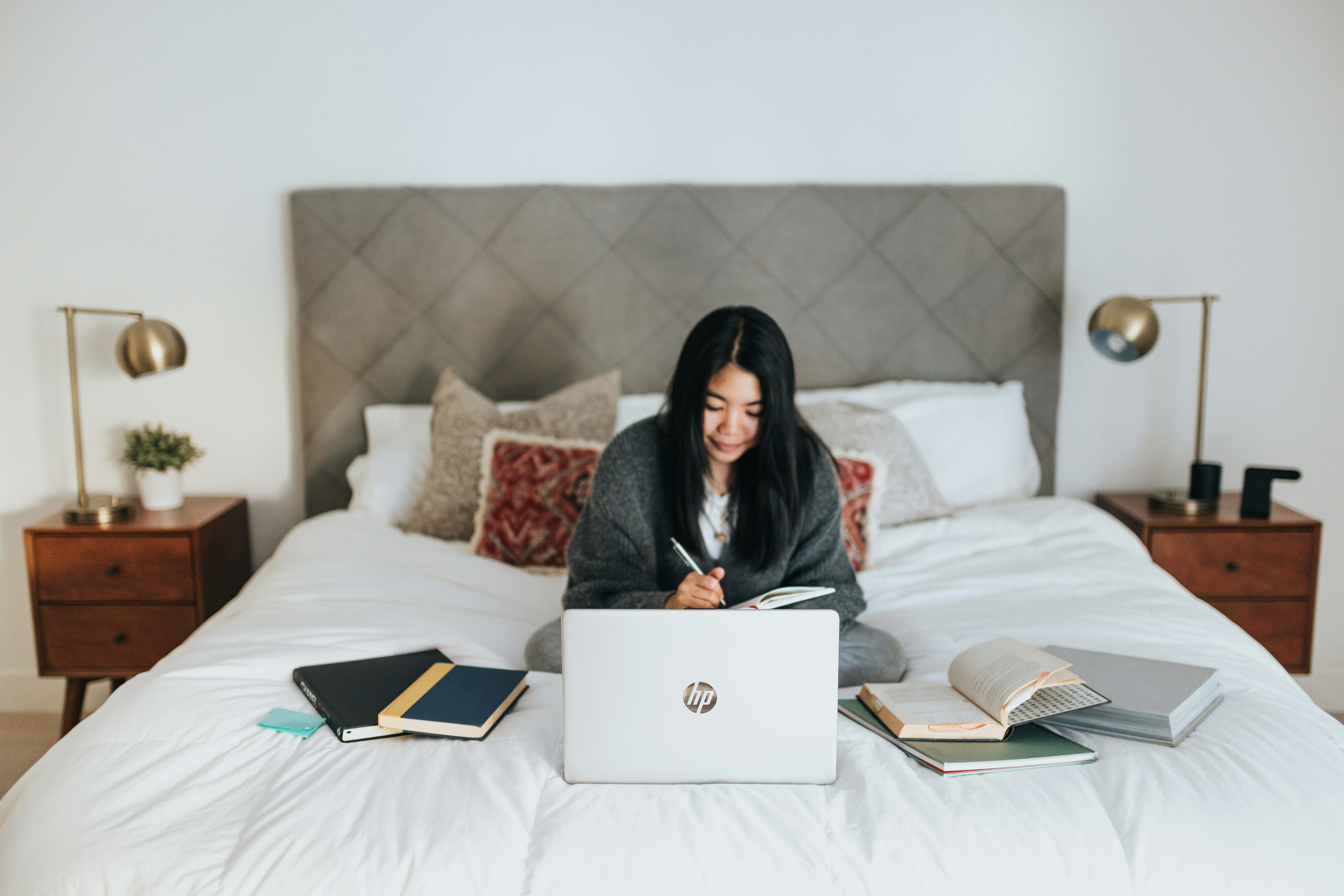 woman on bed finding Sources For Research Paper