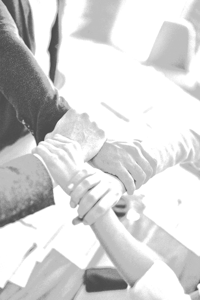 person in black long sleeve shirt holding persons hand