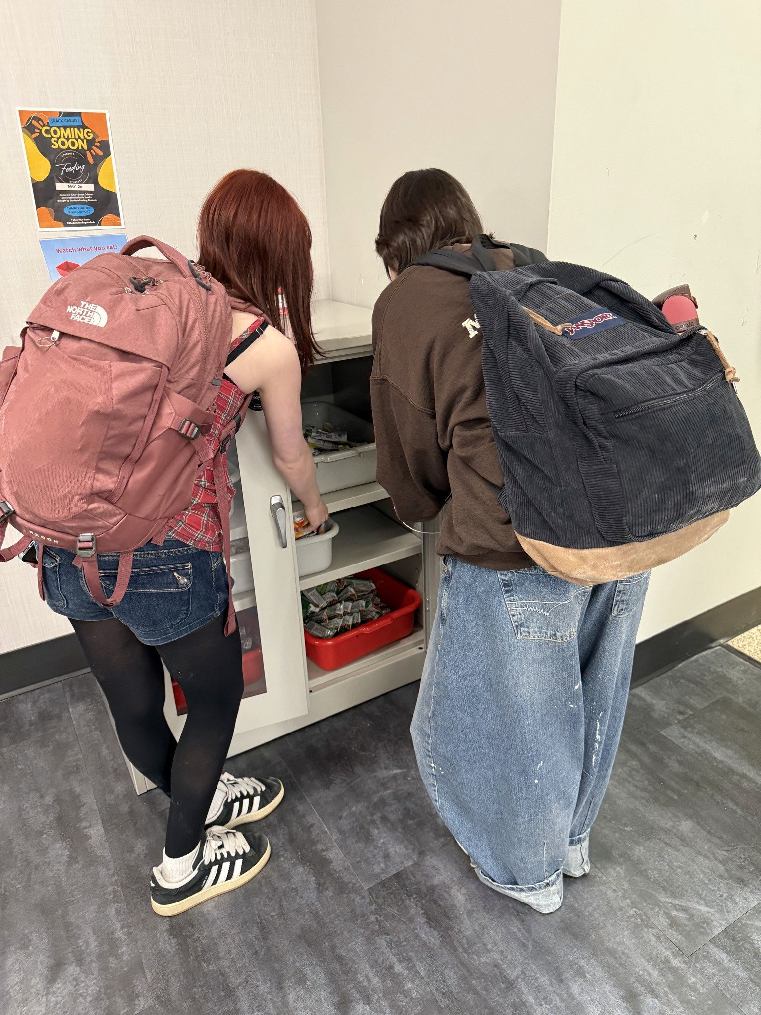Students taking snacks from a snack cabinet at OPRF High School