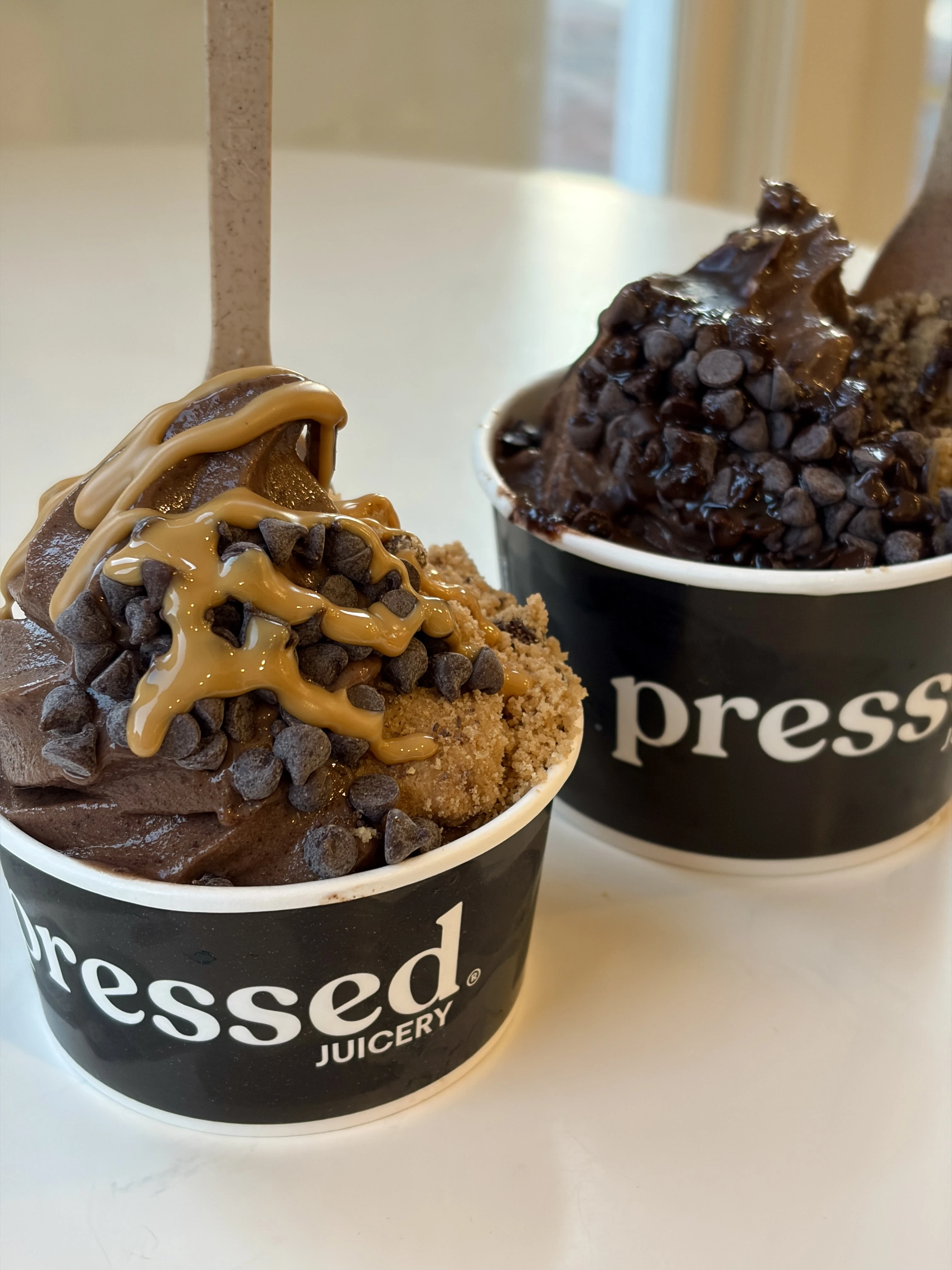 Pressed Juicery chocolate freeze with toppings of vegan chocolate chips, gluten-free cookie crumbles and almond or chocolate drizzle