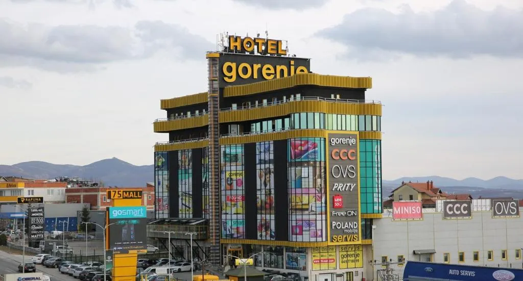Hotel Gorenje in Pristina, Kosovo, featuring a modern glass façade, bold signage, and commercial surroundings. Architectural planning and supervision by Terraplan Partners.