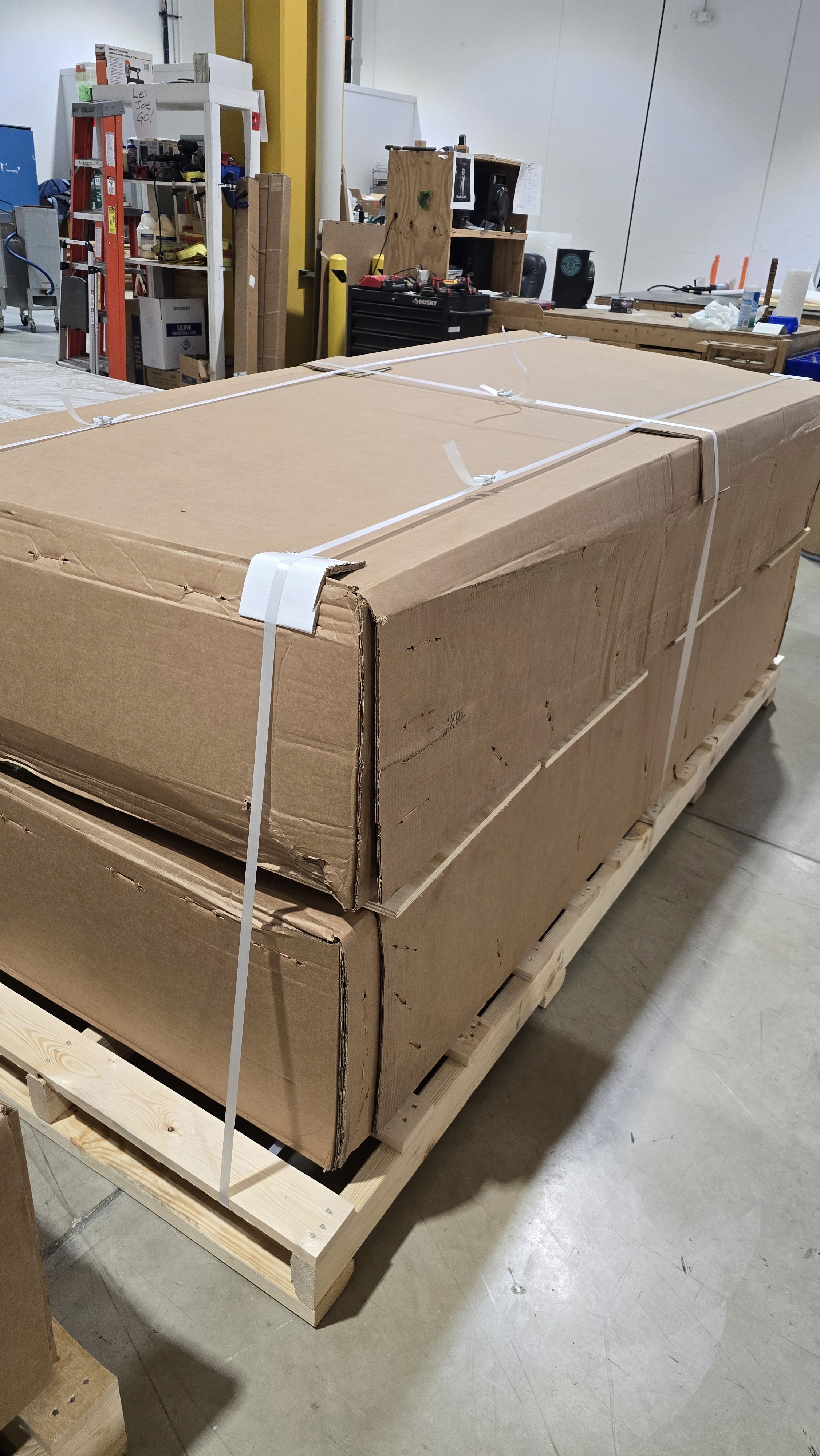 Close-up of a dark green leaf showing its textured surface and central vein against a muted background.