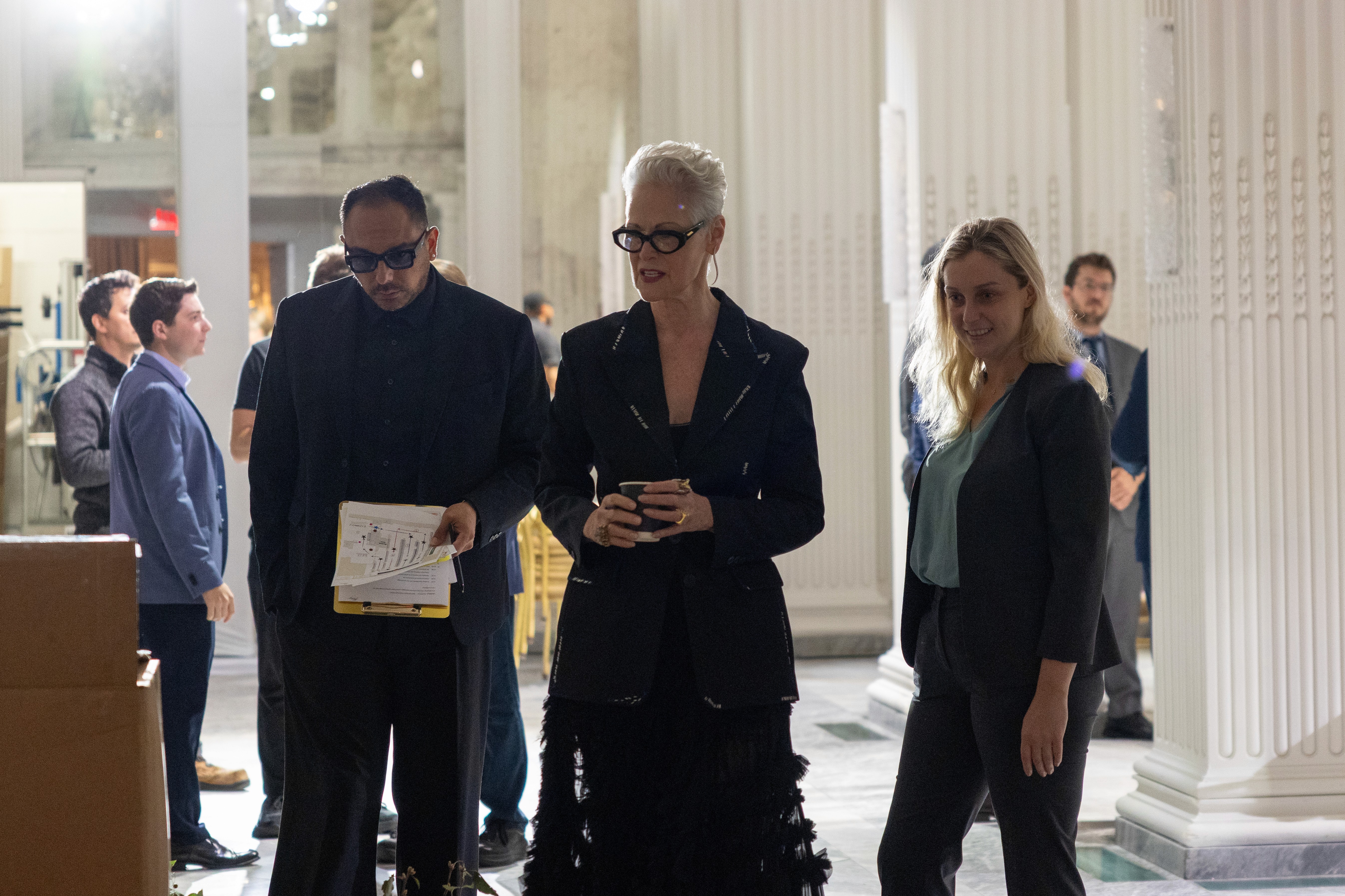 Family floating in pool on blue and white swim rings.