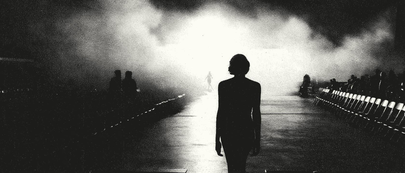 Visual Engineering by Aventi: Medium long shot of a model entering a minimalist runway. Backlit silhouette against a massive brutalist wall, wearing an oversized sculptural black coat. Engineered rim lighting to separate subject from background, simulating high-end editorial standards using Generative AI.