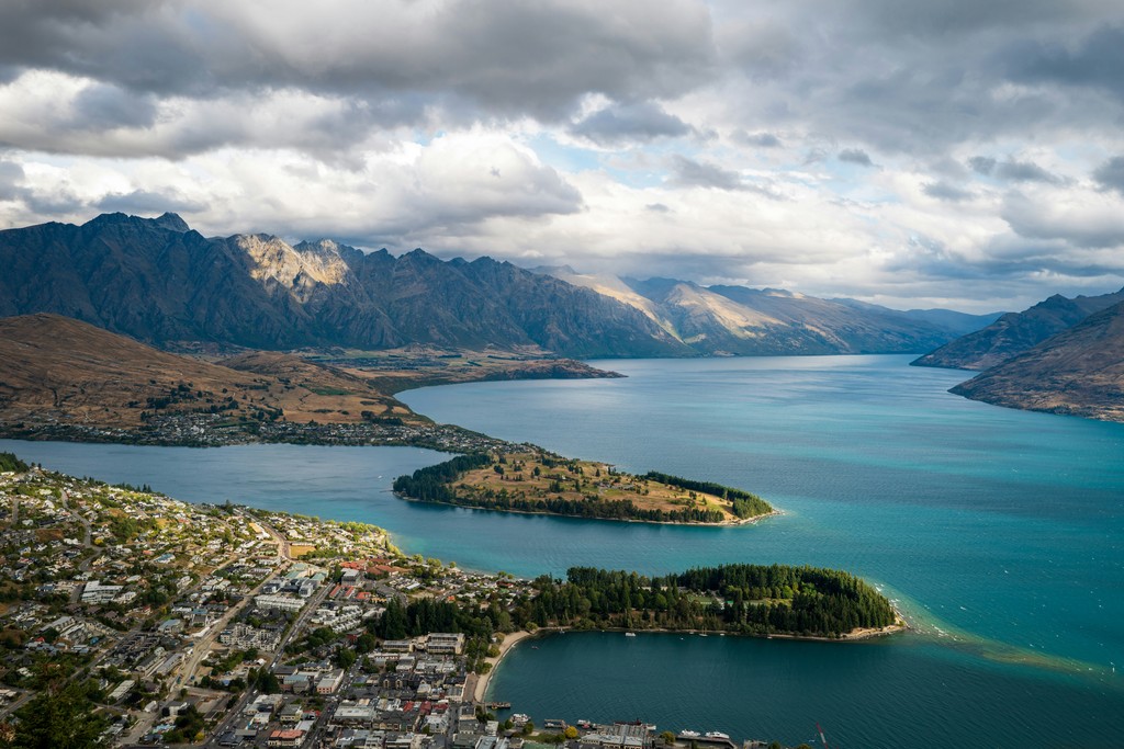 an aerial view of a lake surrounded by mountains
