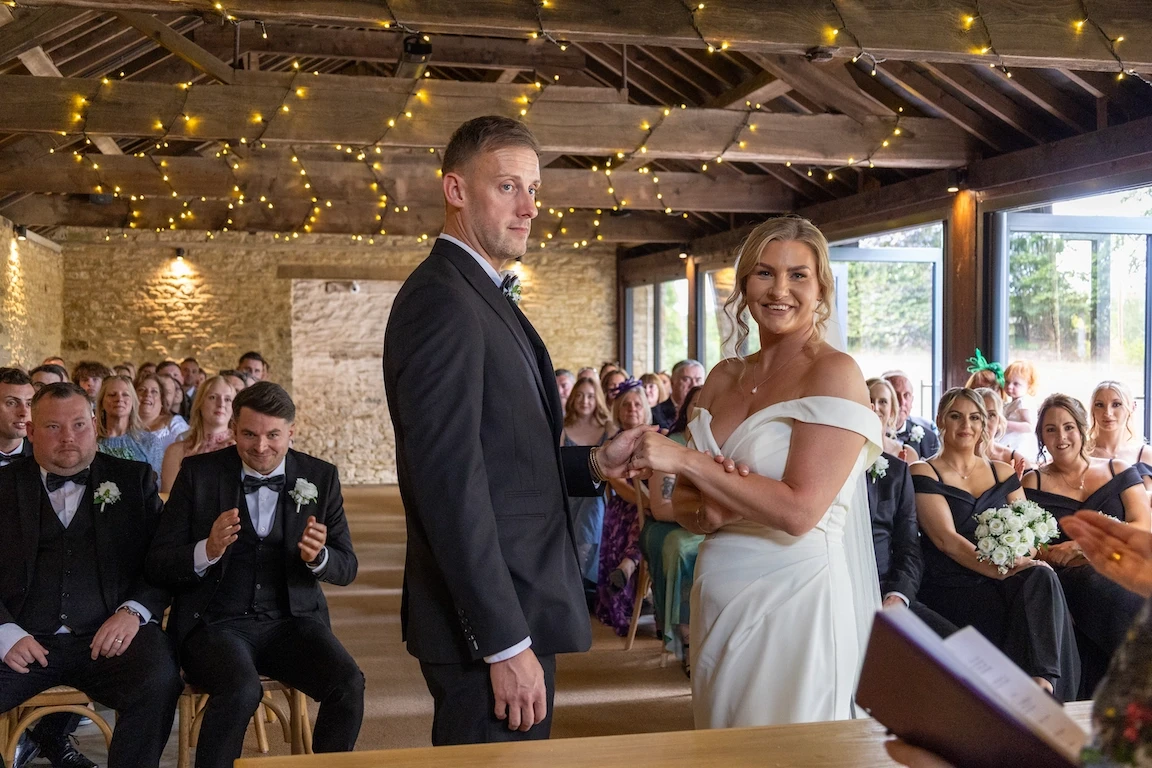 Charlotte and Chris during their wedding ceremony at The Great Barn Aynho in Oxfordshire