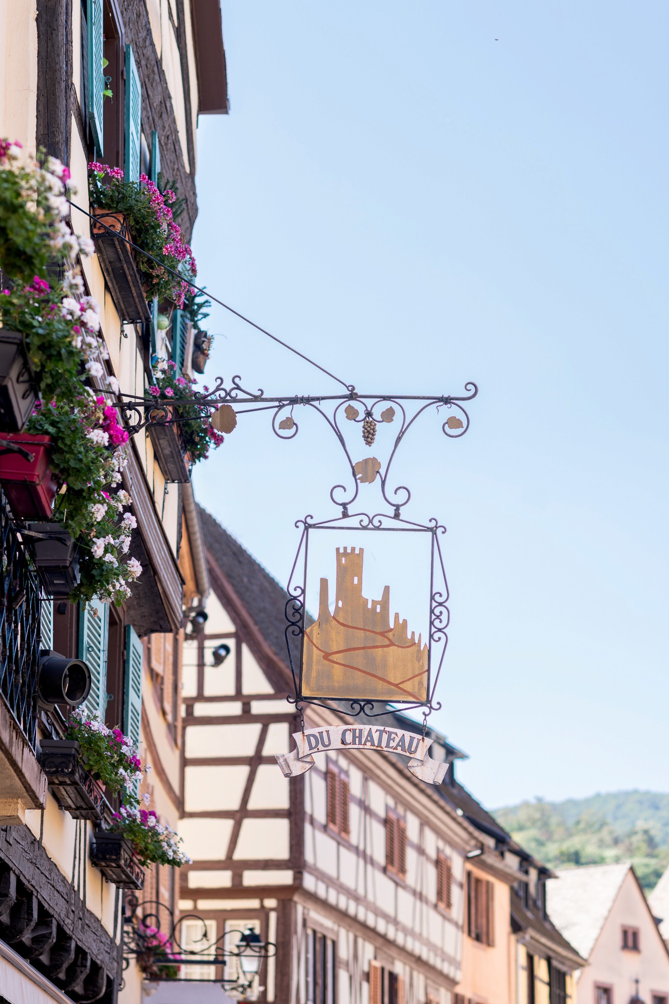 Restaurant bar with guests seated at tables and bartenders at work.