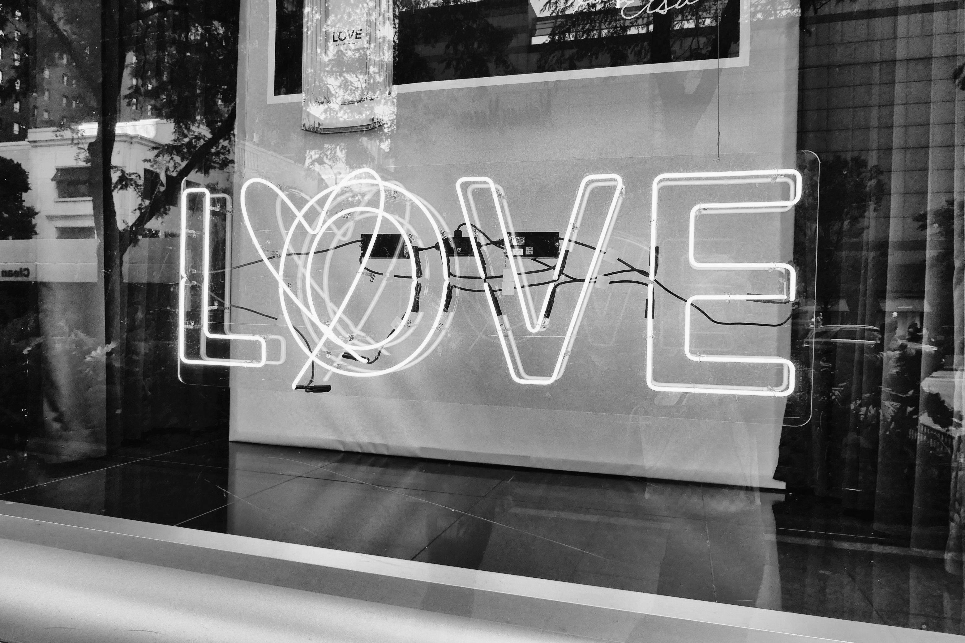 Three people sitting on a couch in a room looking at mobile devices