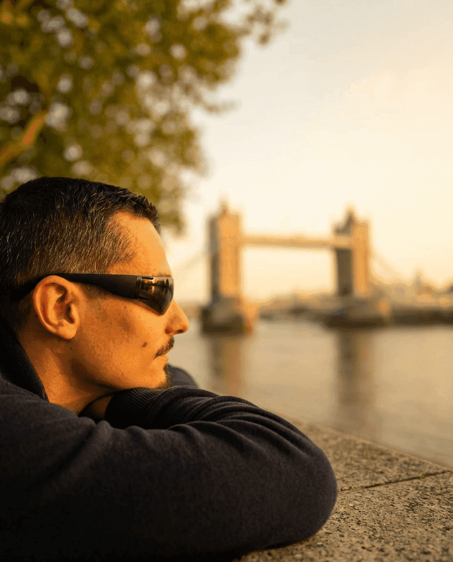Portrait of Florian Humeniuk, in profile, in front of Tower Bridge in London at sunset