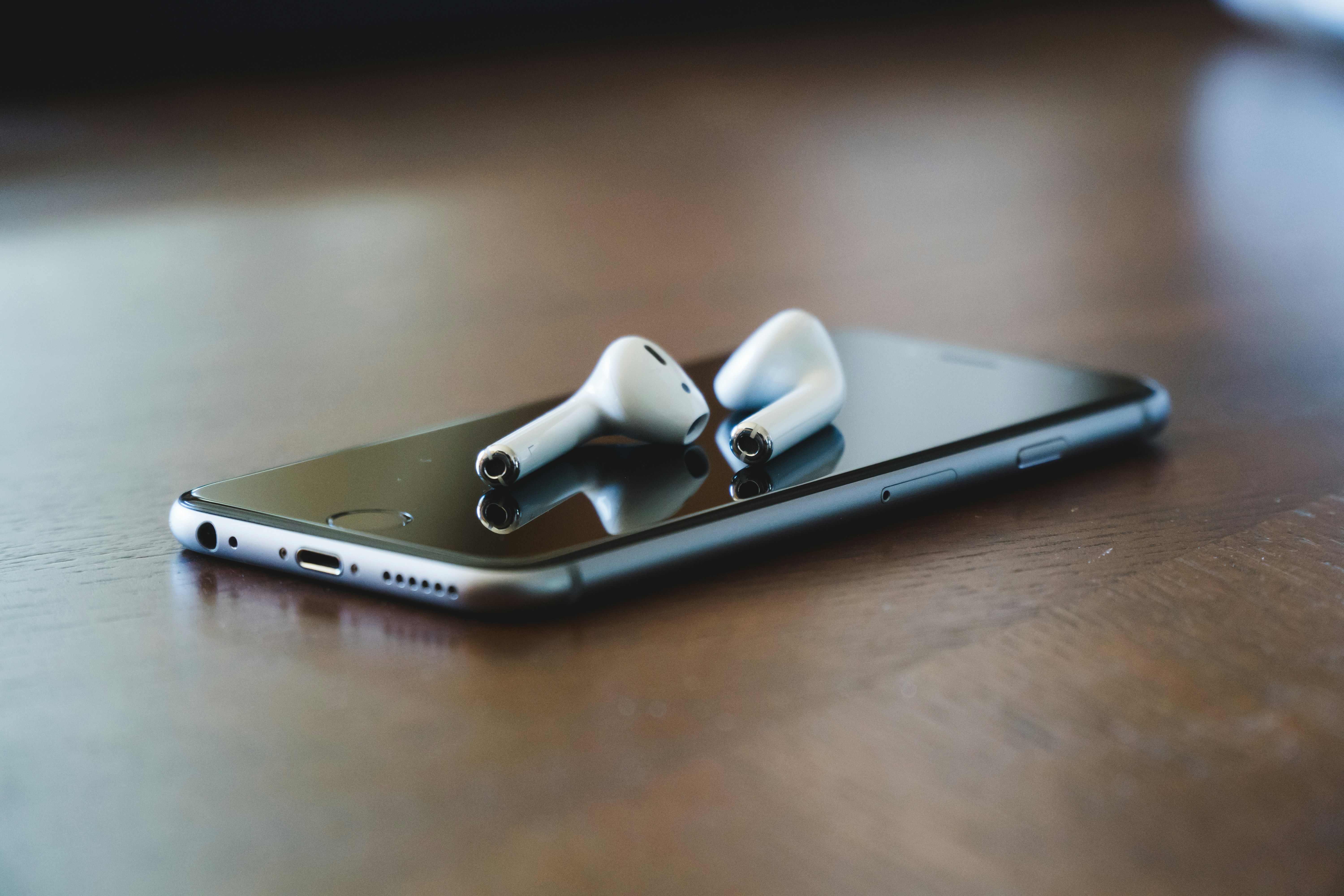 Airpods Laying on Phone - How To Get More Plays On Soundcloud