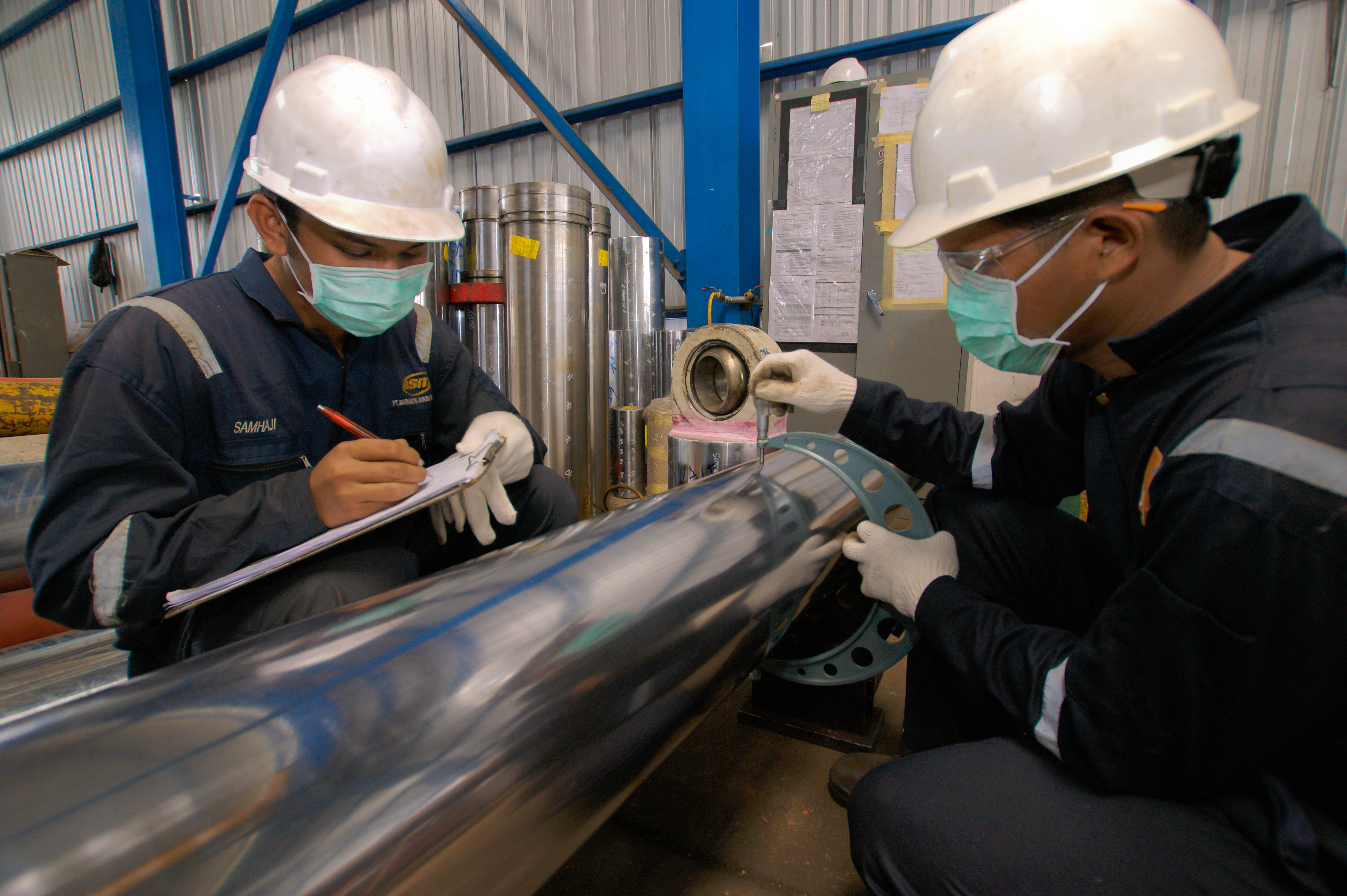 Cargo containers being loaded at the Port of Baltimore with cranes in motion.