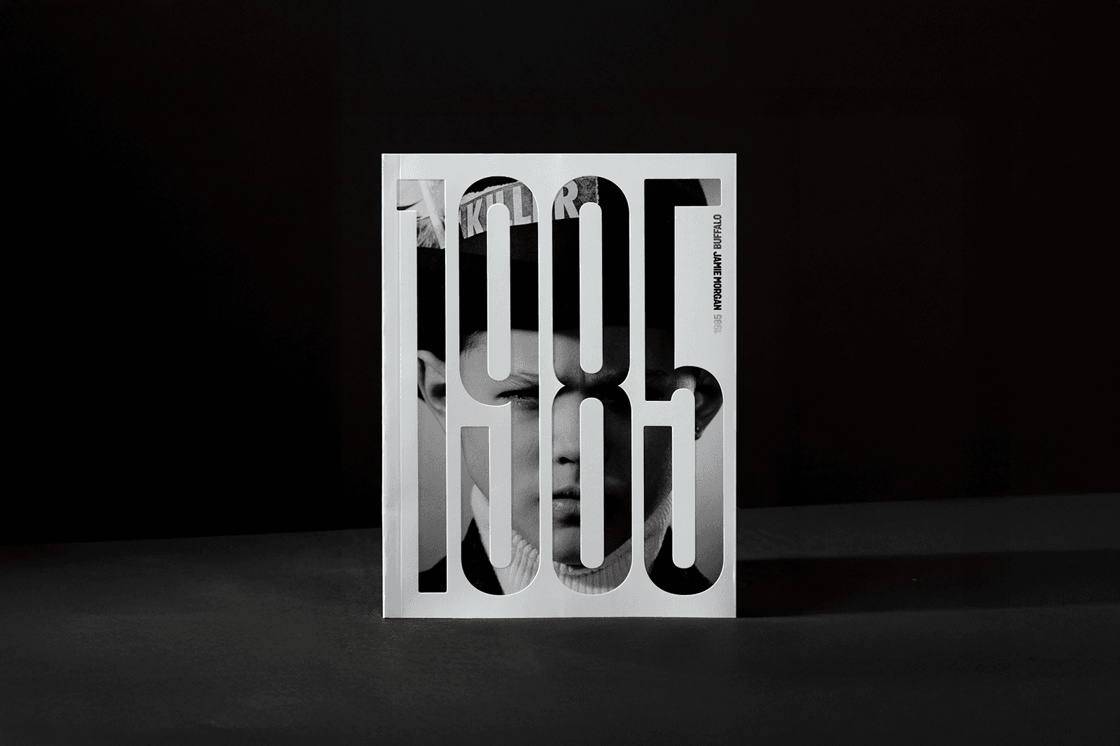 A stylized image featuring the number "1985" in bold, abstract typography against a dark background.