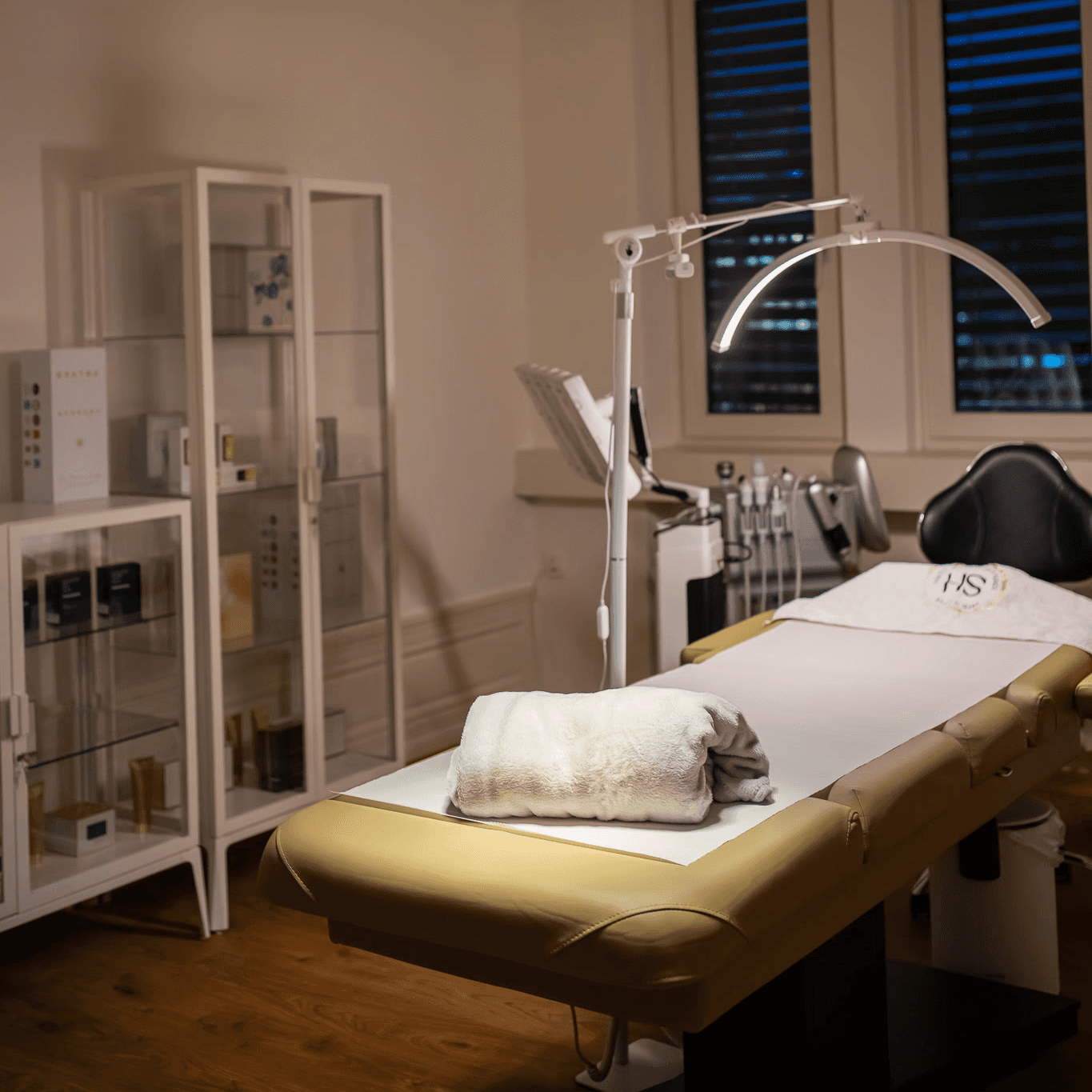 Portrait of a woman with short brown hair, eyes closed, gently holding her face