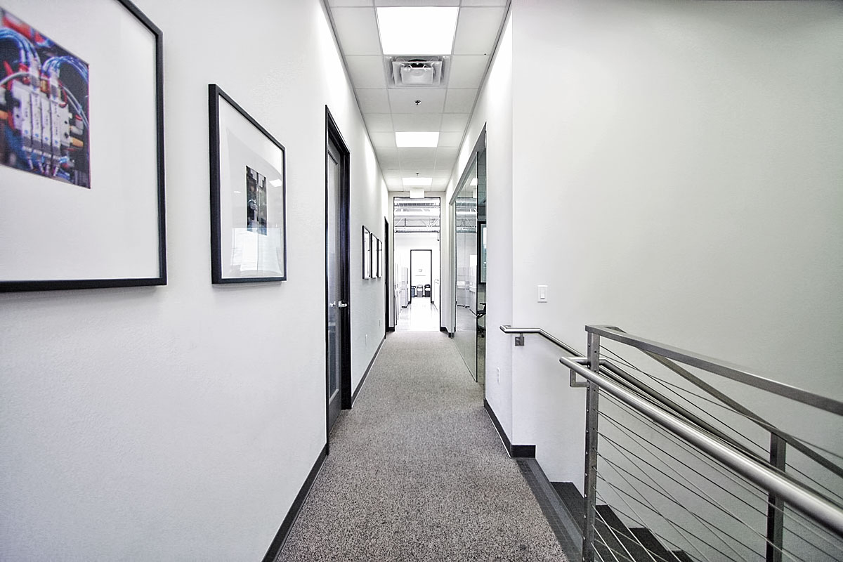 Bright white office hallway, emphasizing clean lines and modern design.