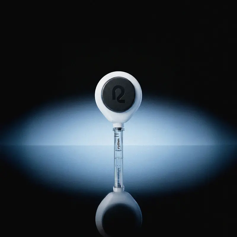 Rythm Health blood testing device centered against a dark gradient background, highlighting its circular design and collection vial.