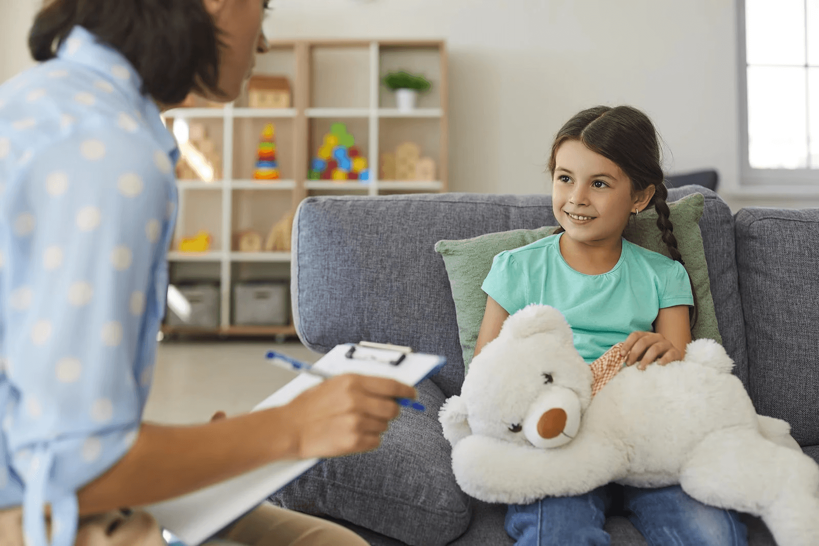 Young girl speaking with a psychologist during a therapy session at Melbourne Children’s Psychology Clinic