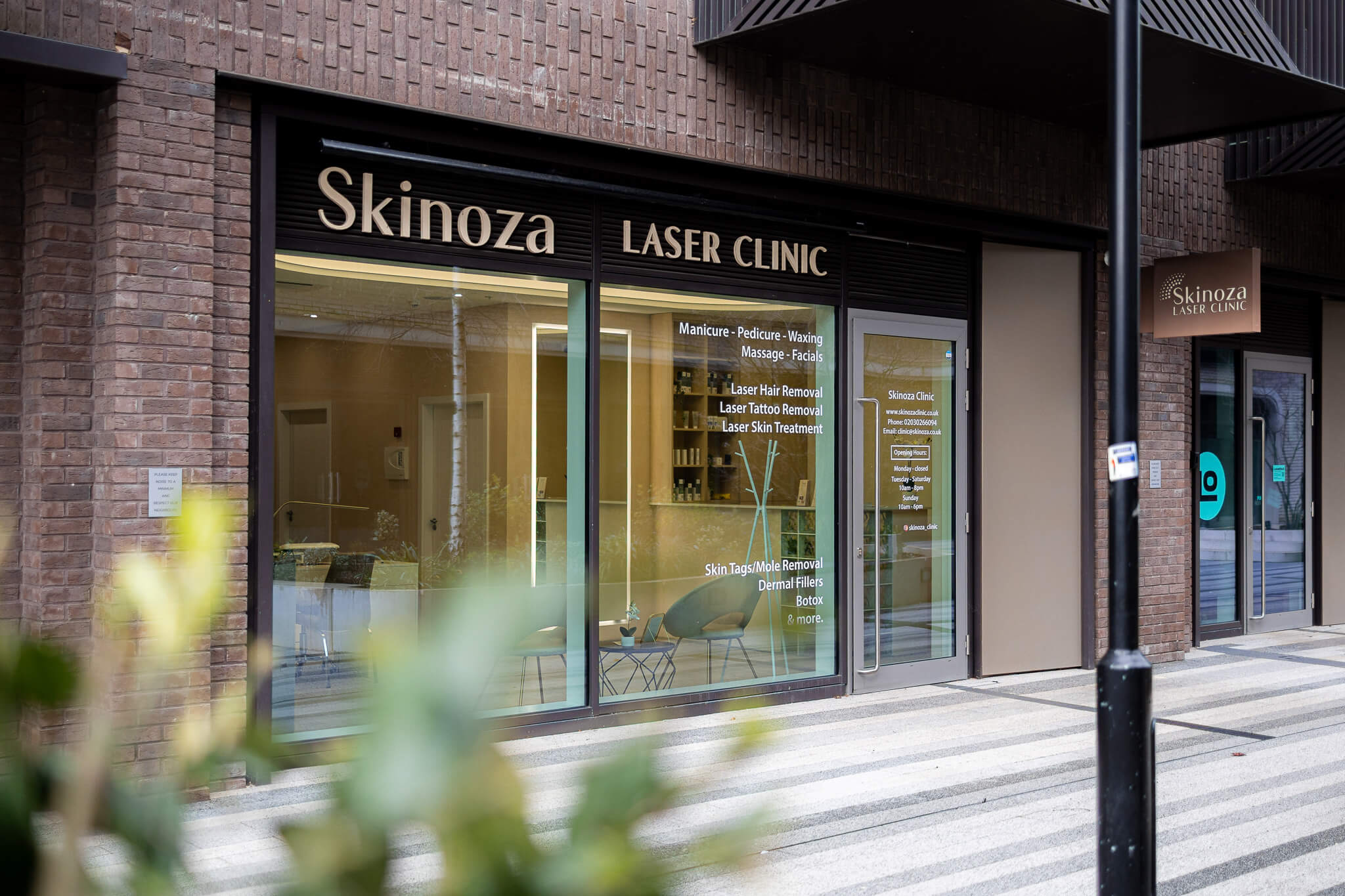 Exterior of Skinoza Laser Clinic storefront in a modern London development.