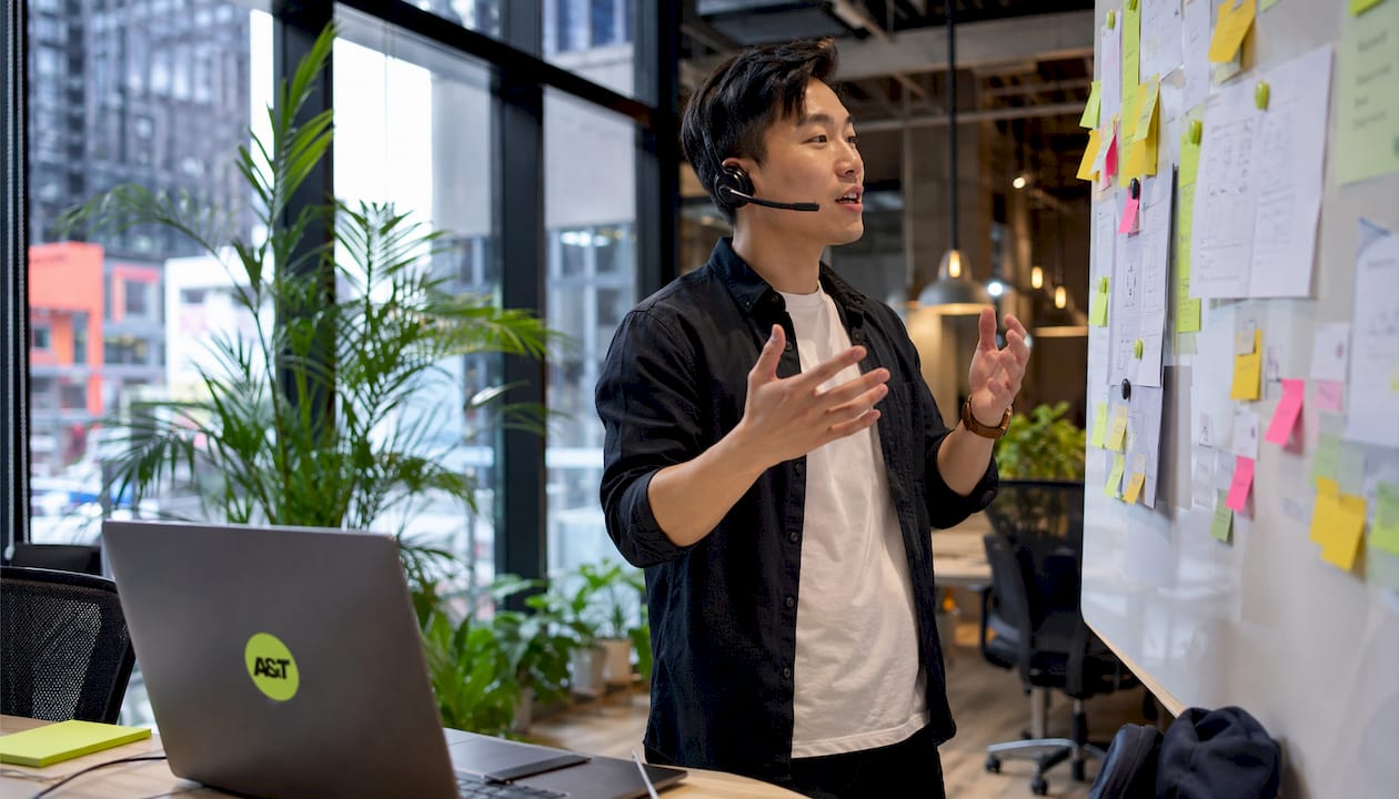 Marketer discussing Google Ads campaign at office desk
