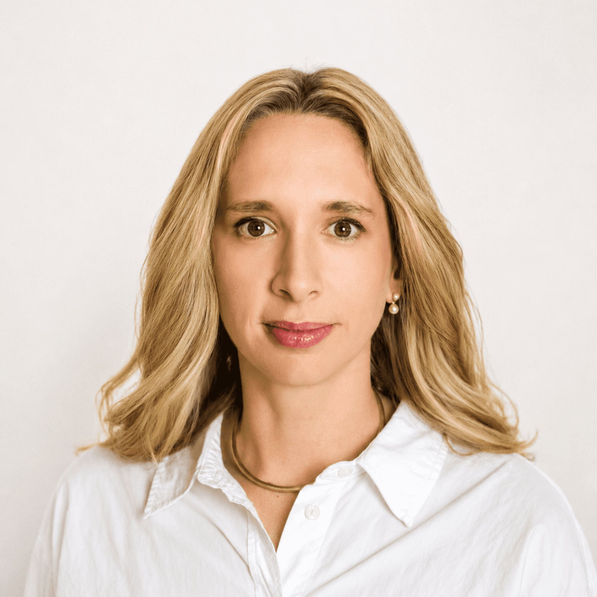 Professional headshot of a MelodyArc team member, a blonde woman in a white collared shirt.