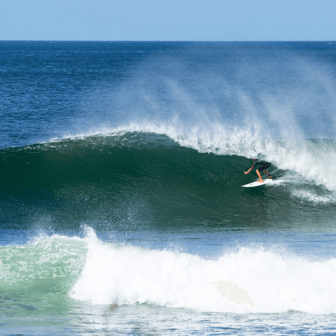 Surfer riding a wave – surfboard rental in nosara.