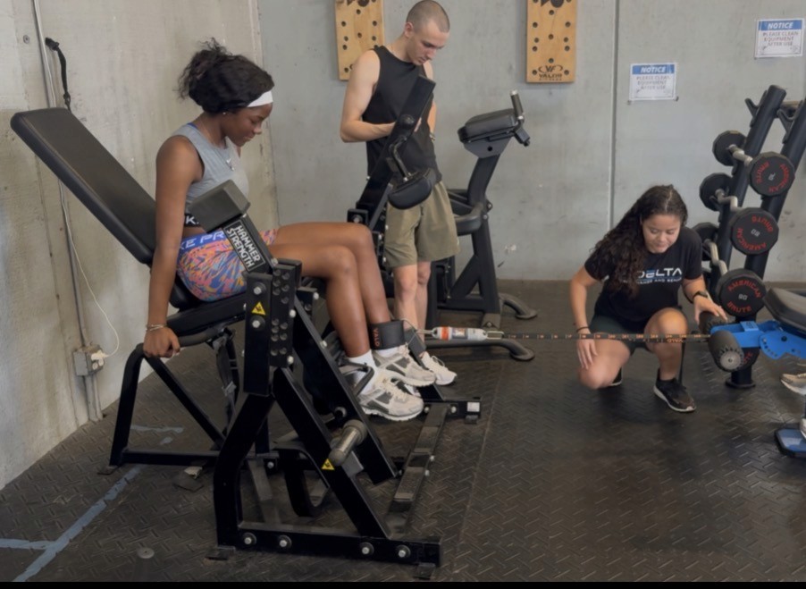 Group fitness class using resistance bands for strength training in a gym setting—emphasizing community wellness, rehab-friendly exercise, and functional movement.