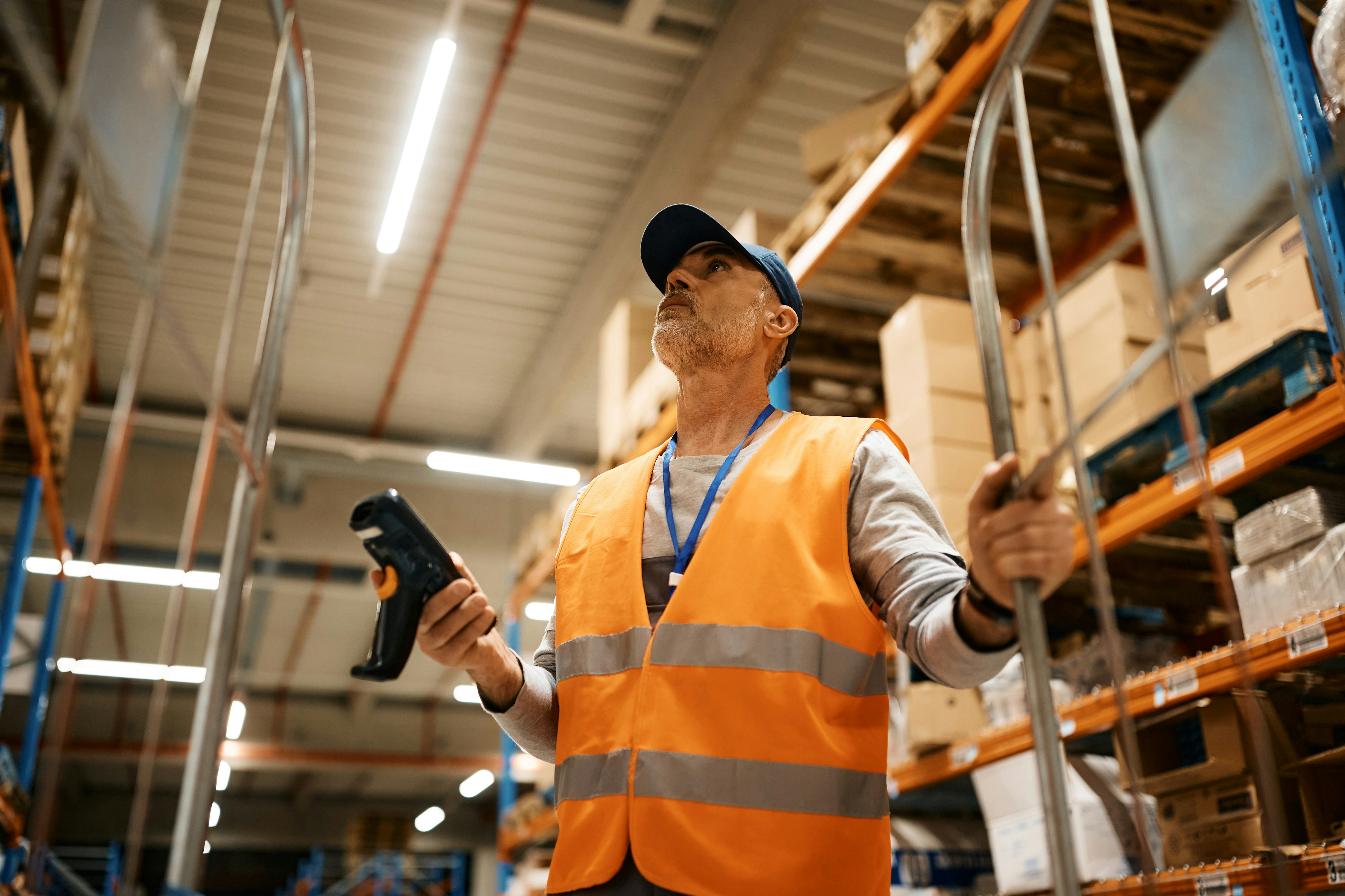 warehouse worker using a scanner to find items
