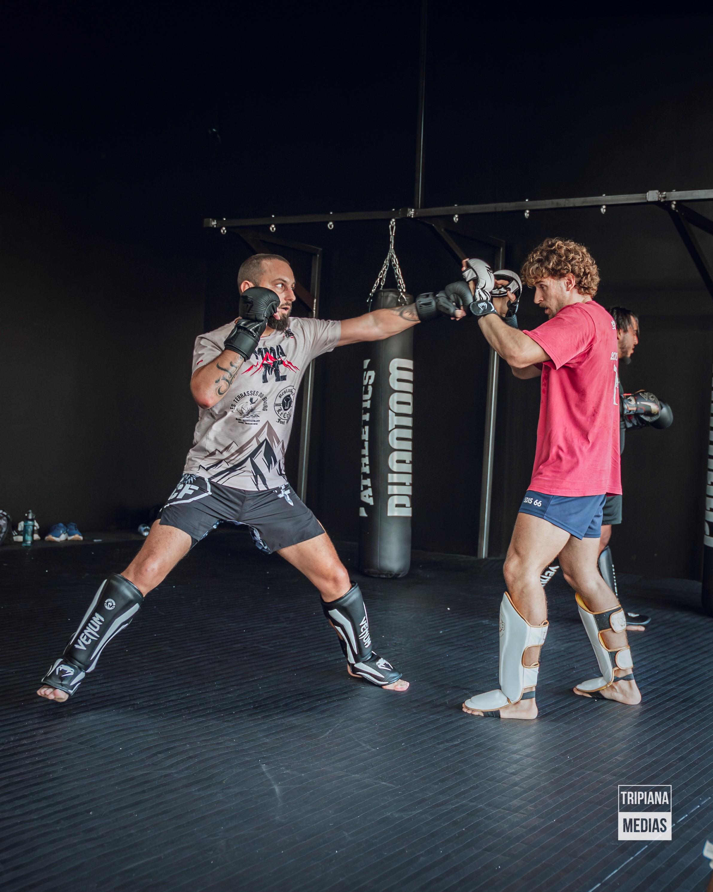 a man with no shirt wearing boxing gloves