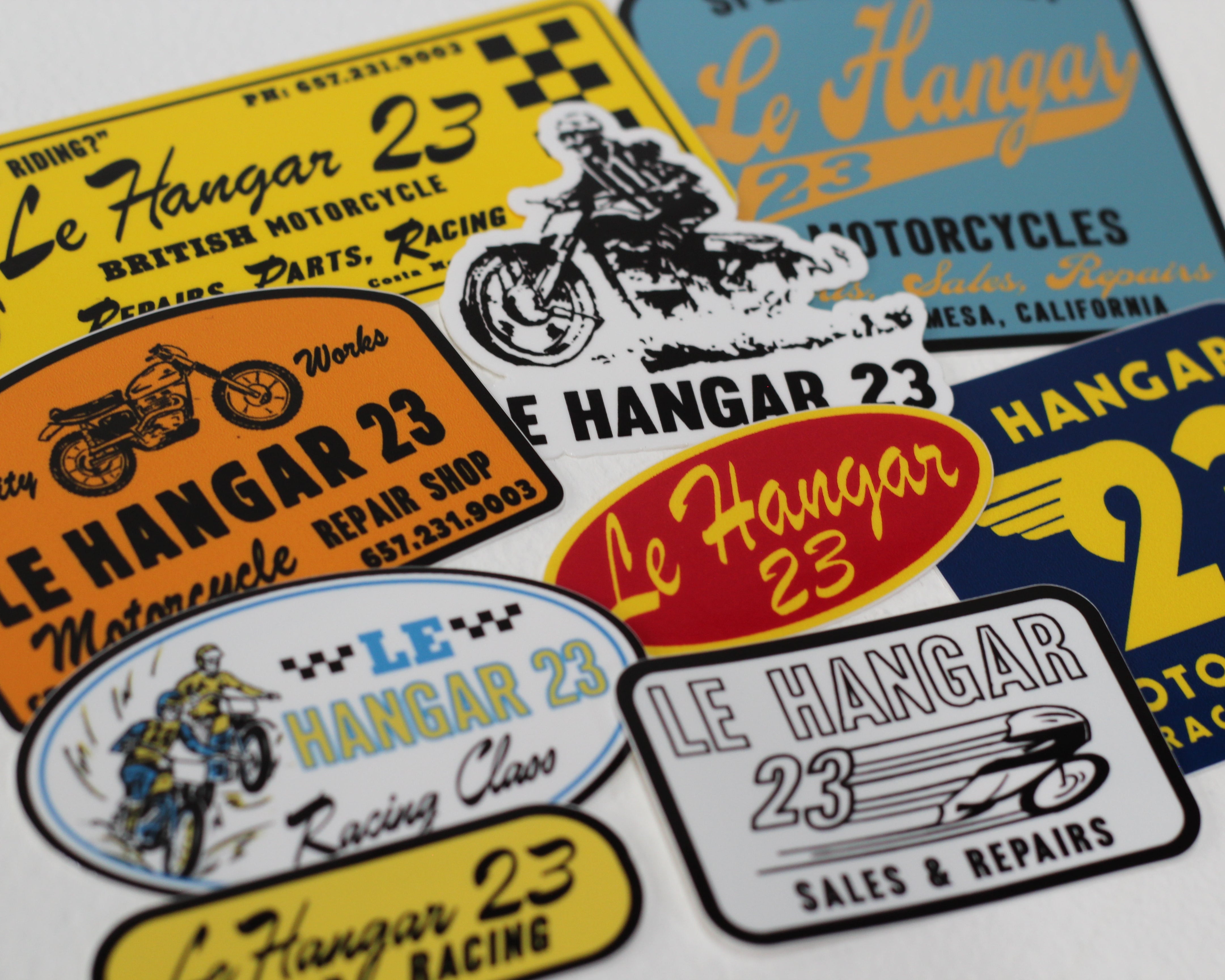 Collection of Le Hangar 23 motorcycle-themed stickers on a white background