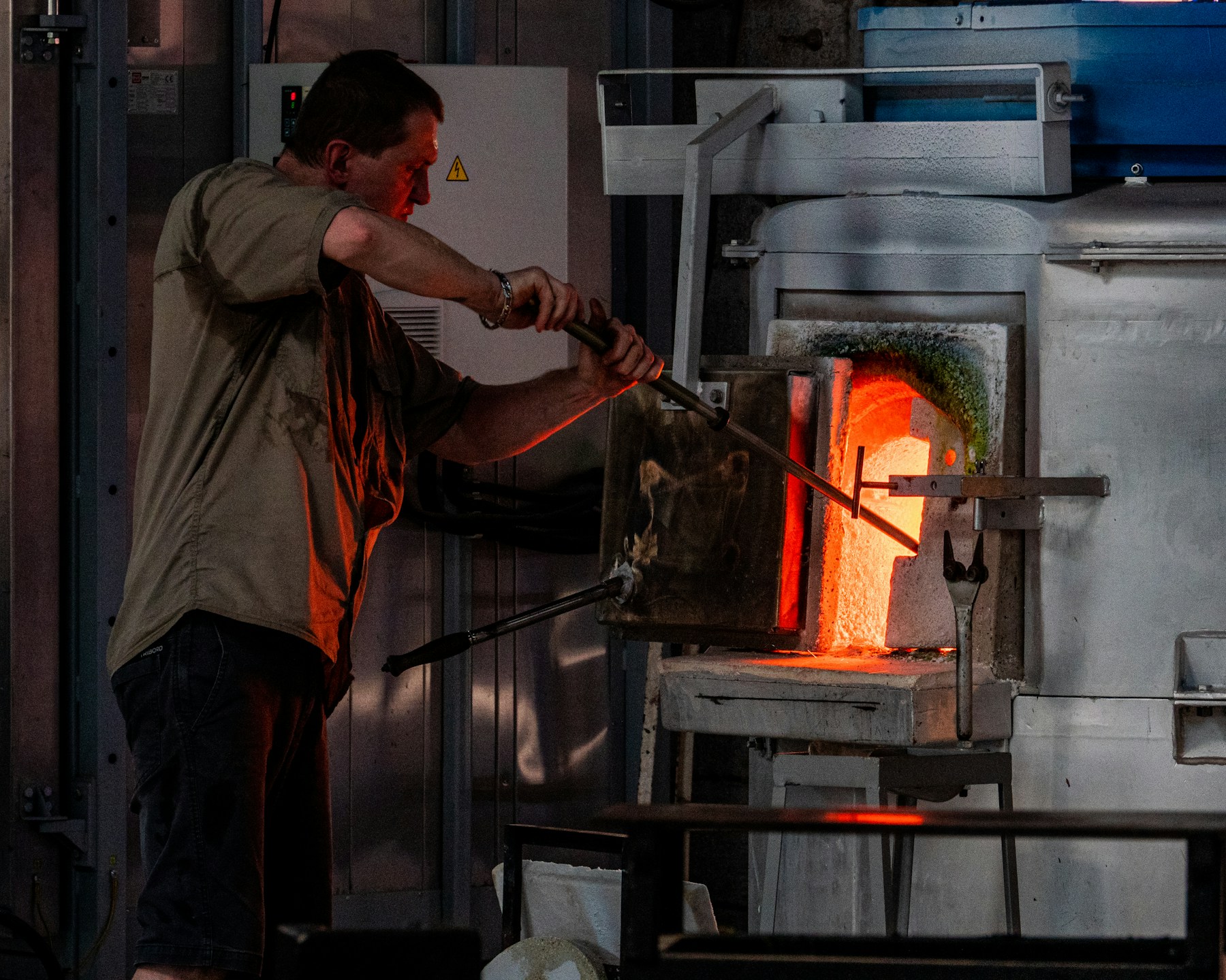 Glowing kiln opening in a dark ceramics workshop