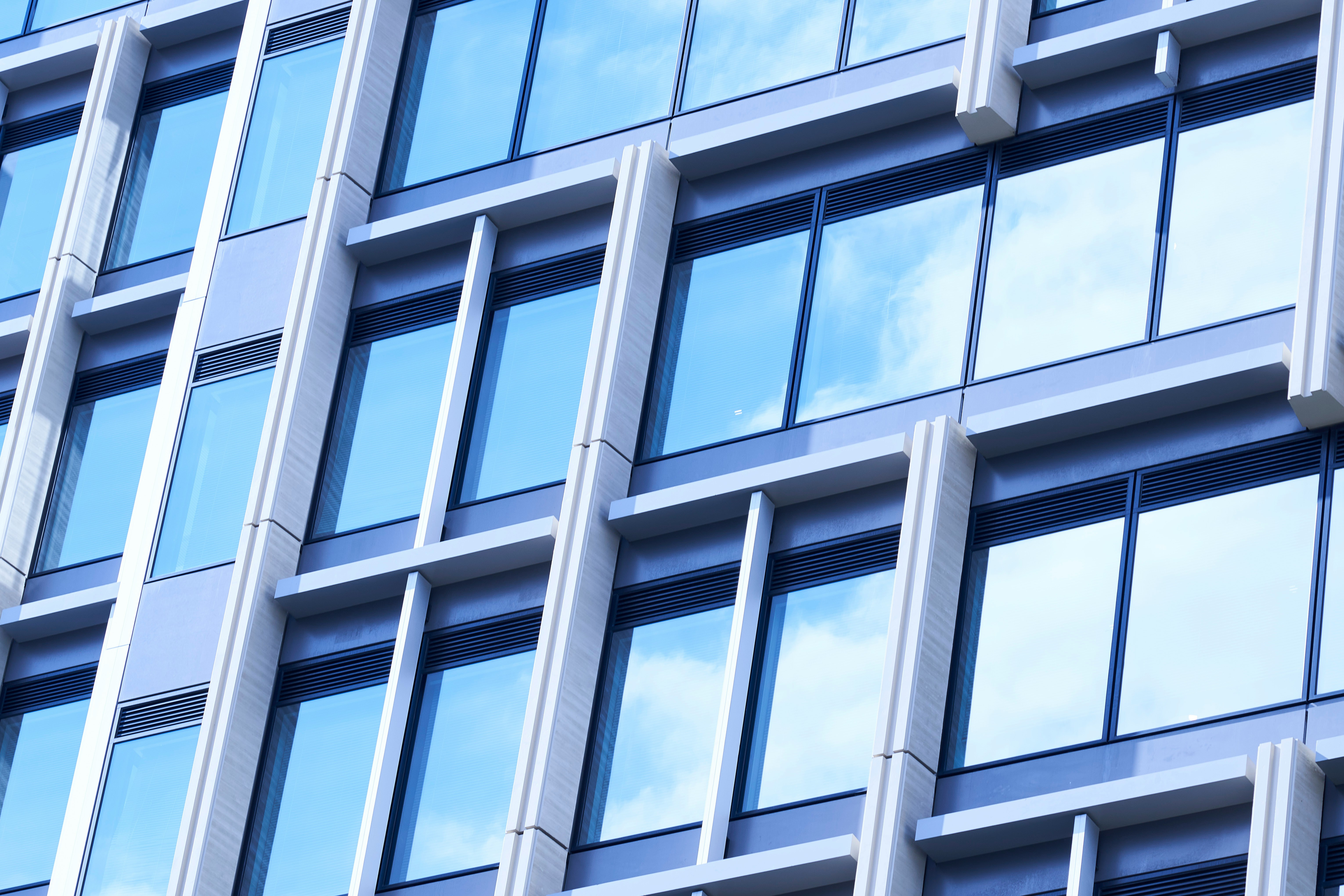 Modern building facade with reflective blue windows.