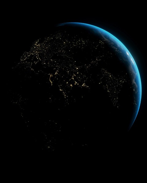 An image of planet earth from space with city lights forming network patterns.