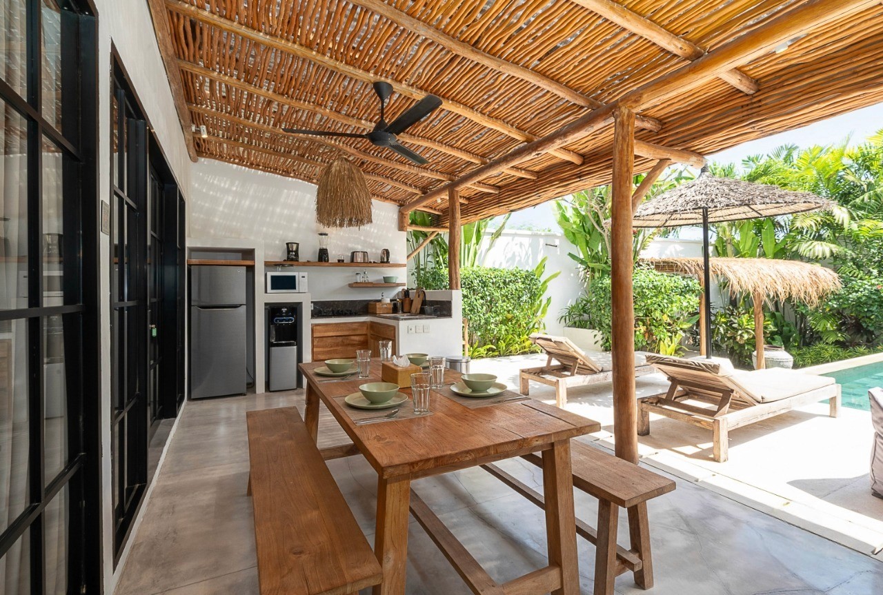 Outdoor dining area by the pool. Specialist real estate agent providing luxury villas for sale at Nyanyi Beach.