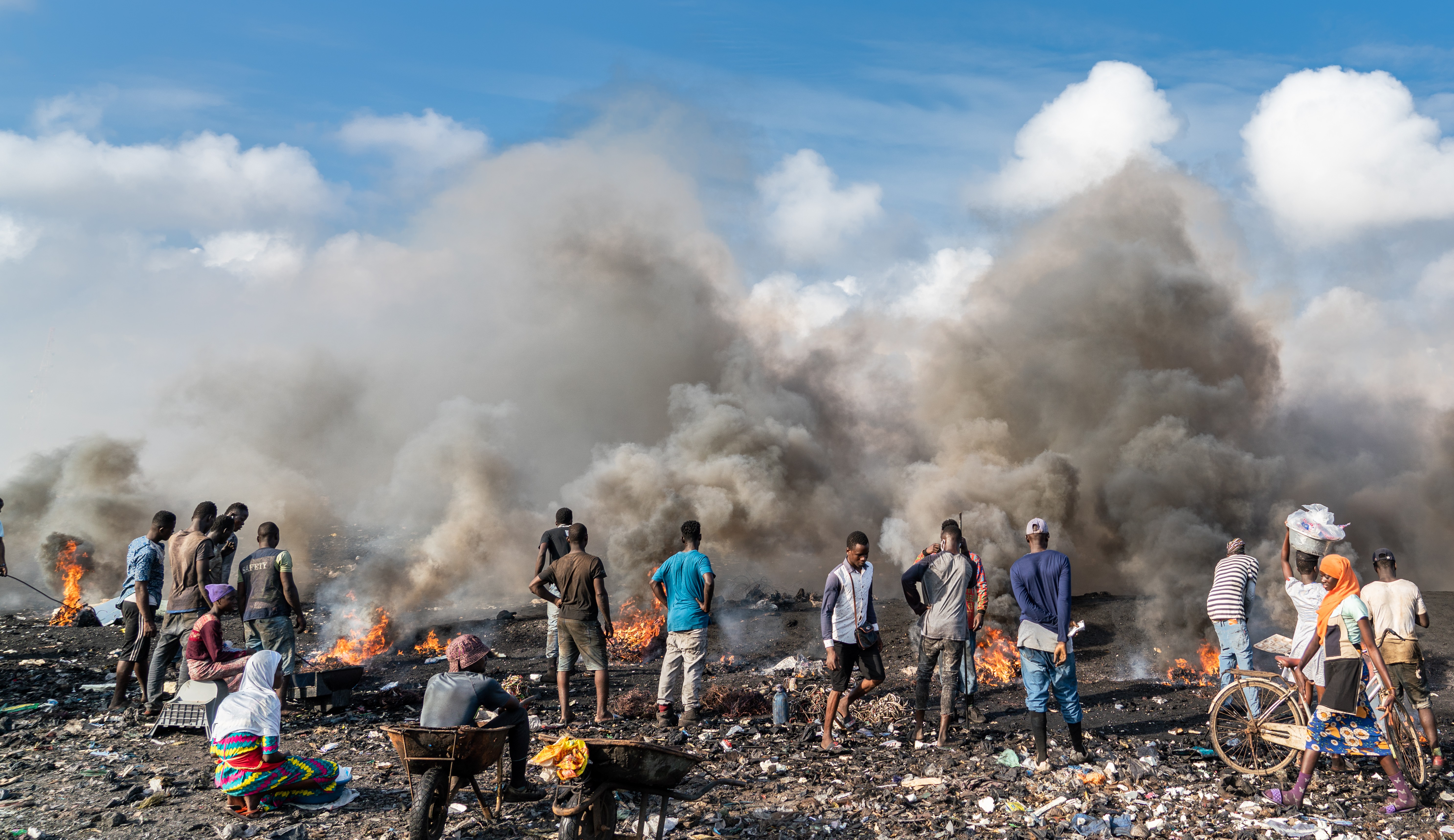 Young men are pictured burning electrical wires to recover copper at Agbogbloshie, Accra, Ghana on September 2, 2019.
