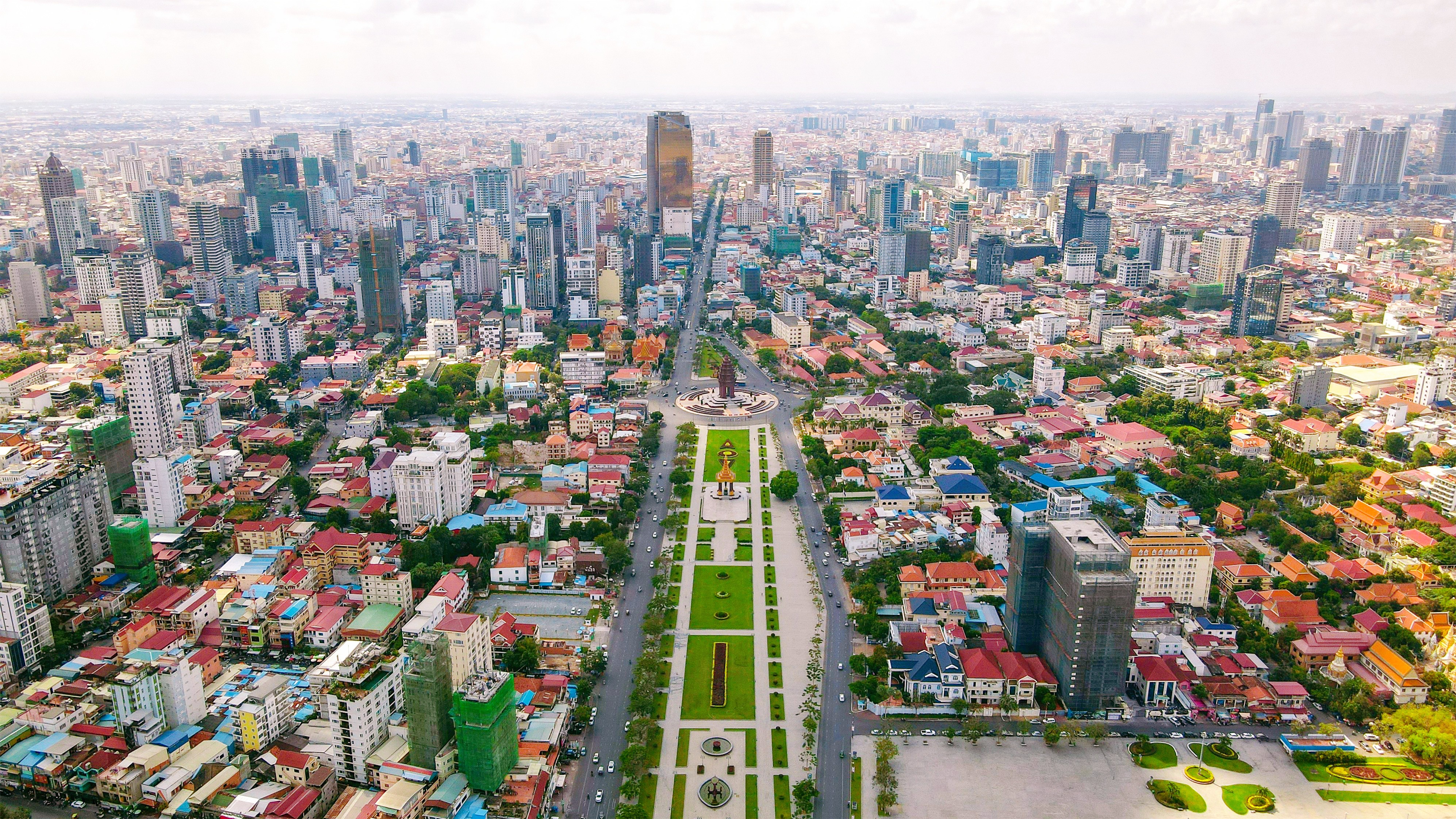Aerial panoramic view of central Phnom Penh, Cambodia, showcasing the city's modern skyline and dense urban area for real estate inquiries.