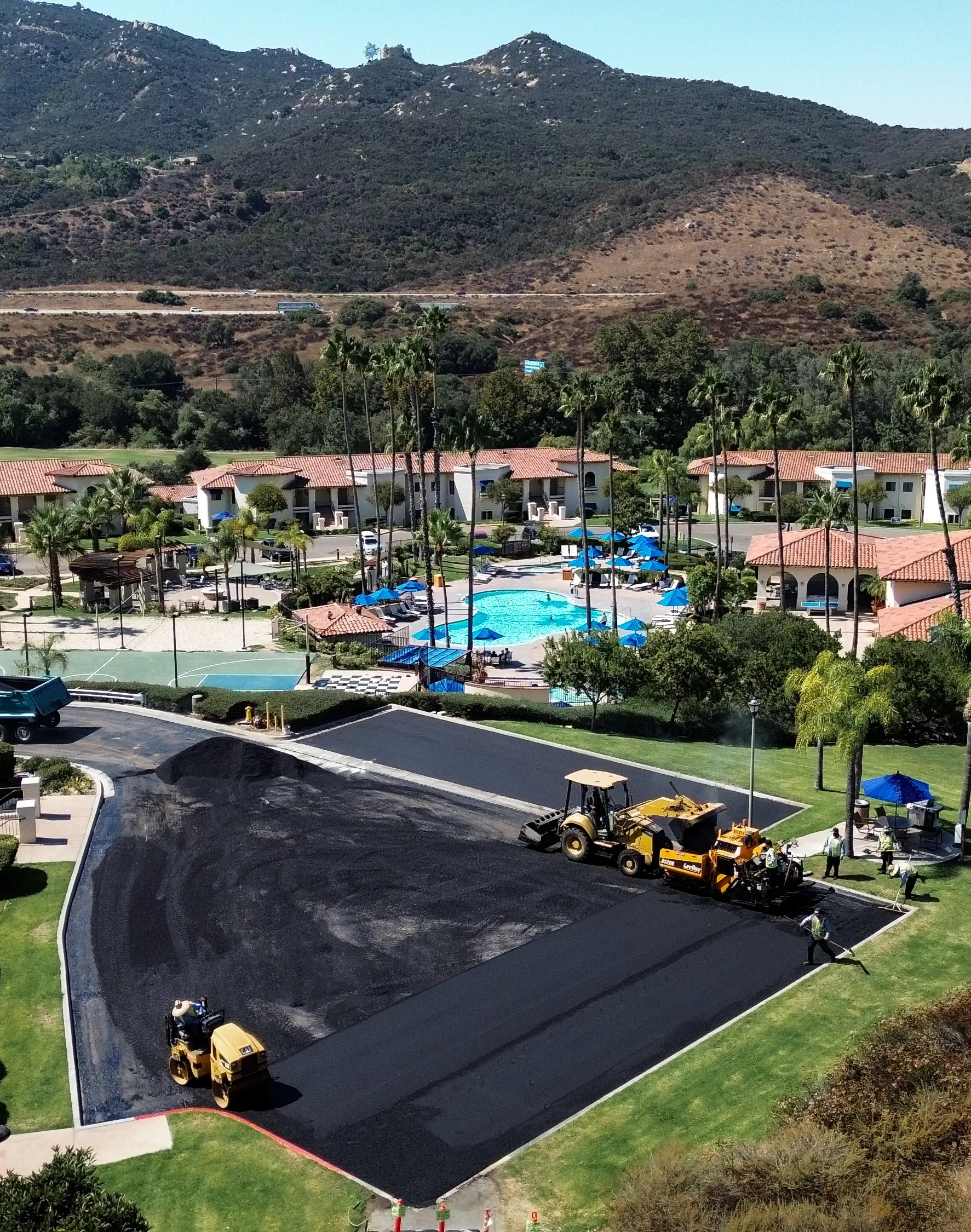 Aerial photo of asphalt crew paving parking lot