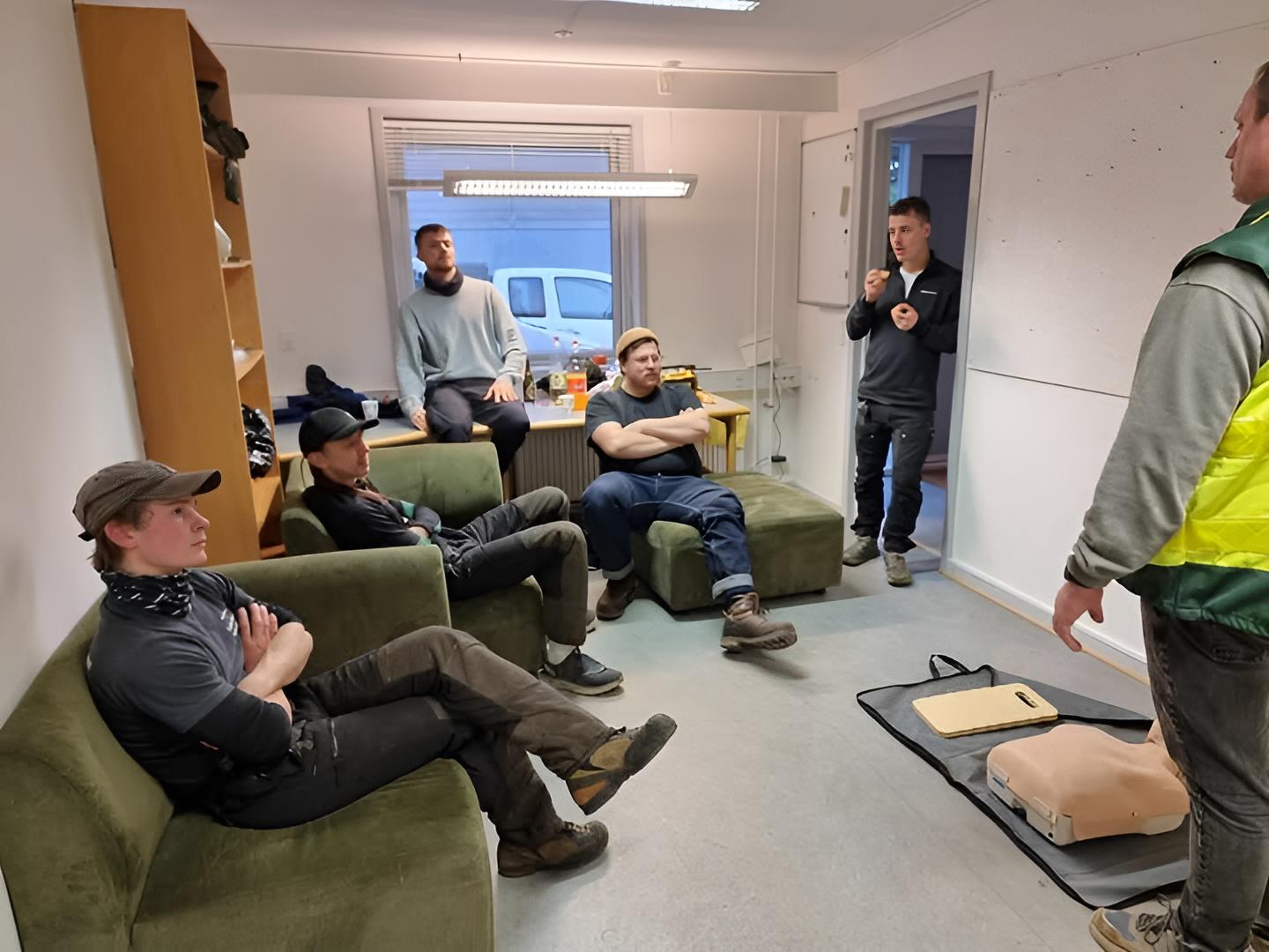 A group of four people engaged in a discussion while seated in a cozy, plant-filled setting.