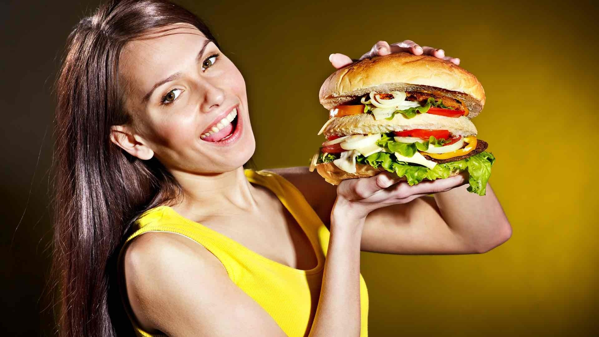 woman holding big burger
