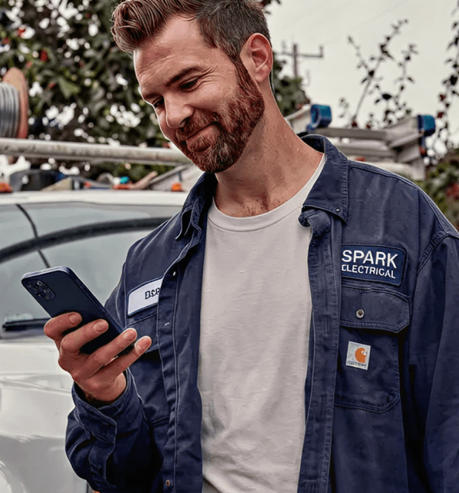 Electrician showing a woman an electrical panel.