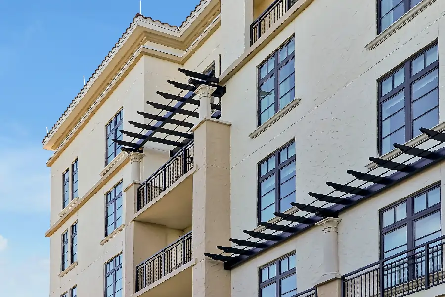 A multi-story building featuring multiple balconies on its exterior, showcasing a modern architectural design.