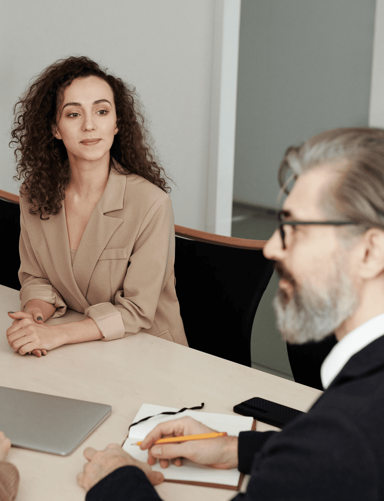 woman in brown coat using macbook air