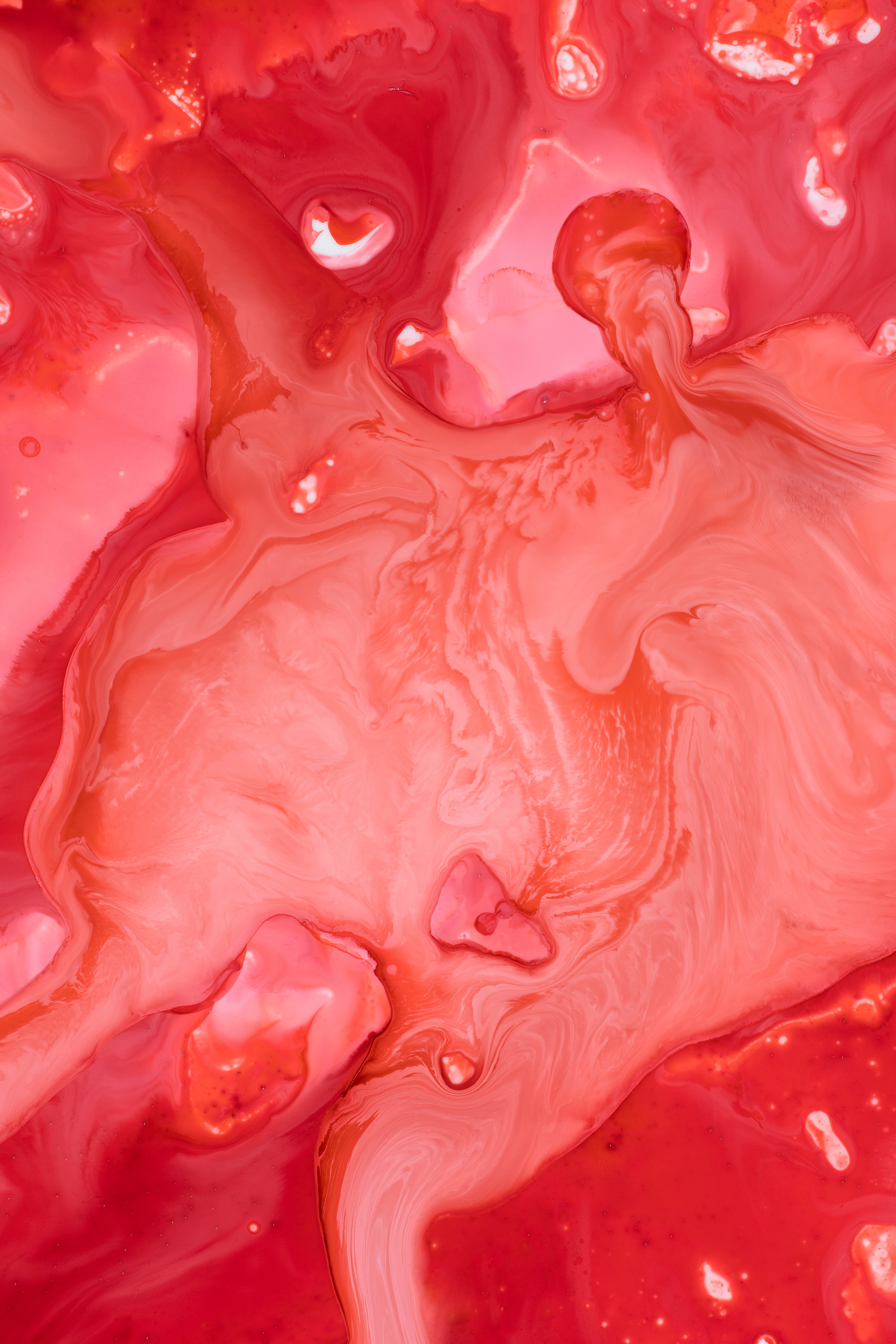 Scientist wearing safety goggles and blue lab attire, using a pipette to transfer liquid into a vial in a laboratory setting.