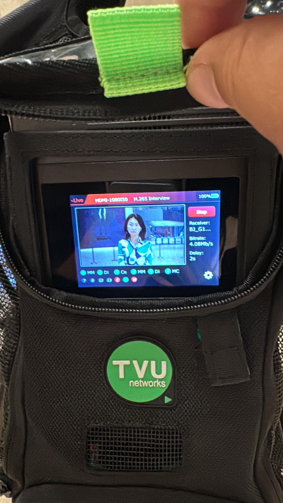 Professional camera filming an outdoor event with people.