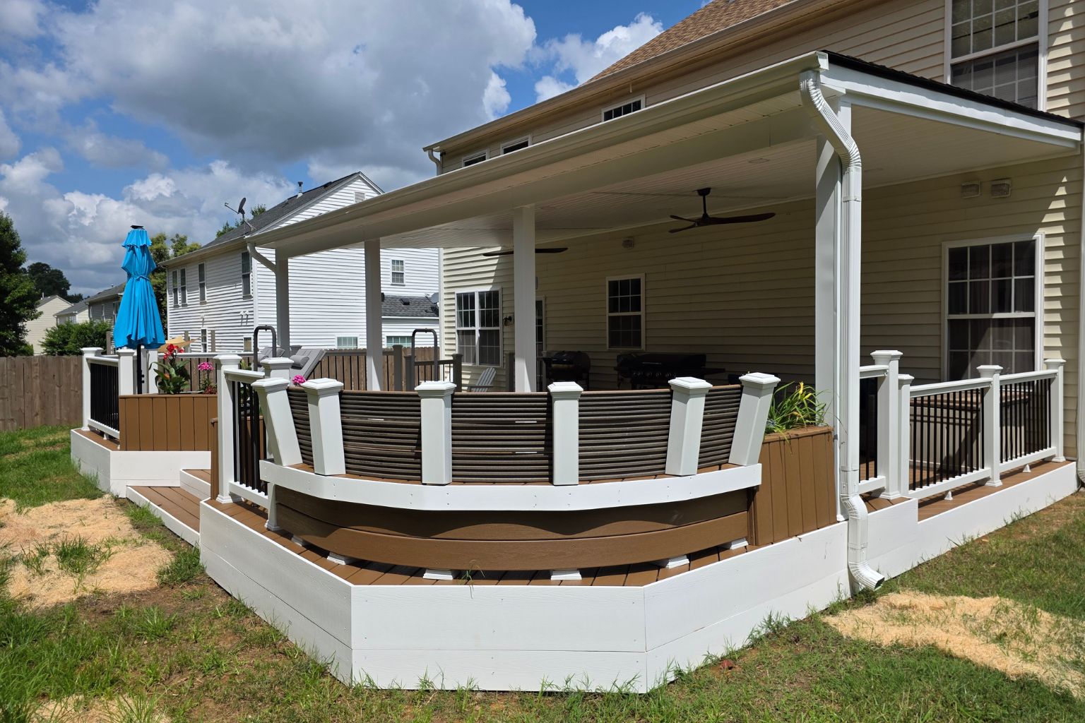 Completed Trex Enhance Beach Dune deck reskin with covered roof addition, vinyl railings, recessed lighting, and outdoor living upgrades in Jamestown NC.