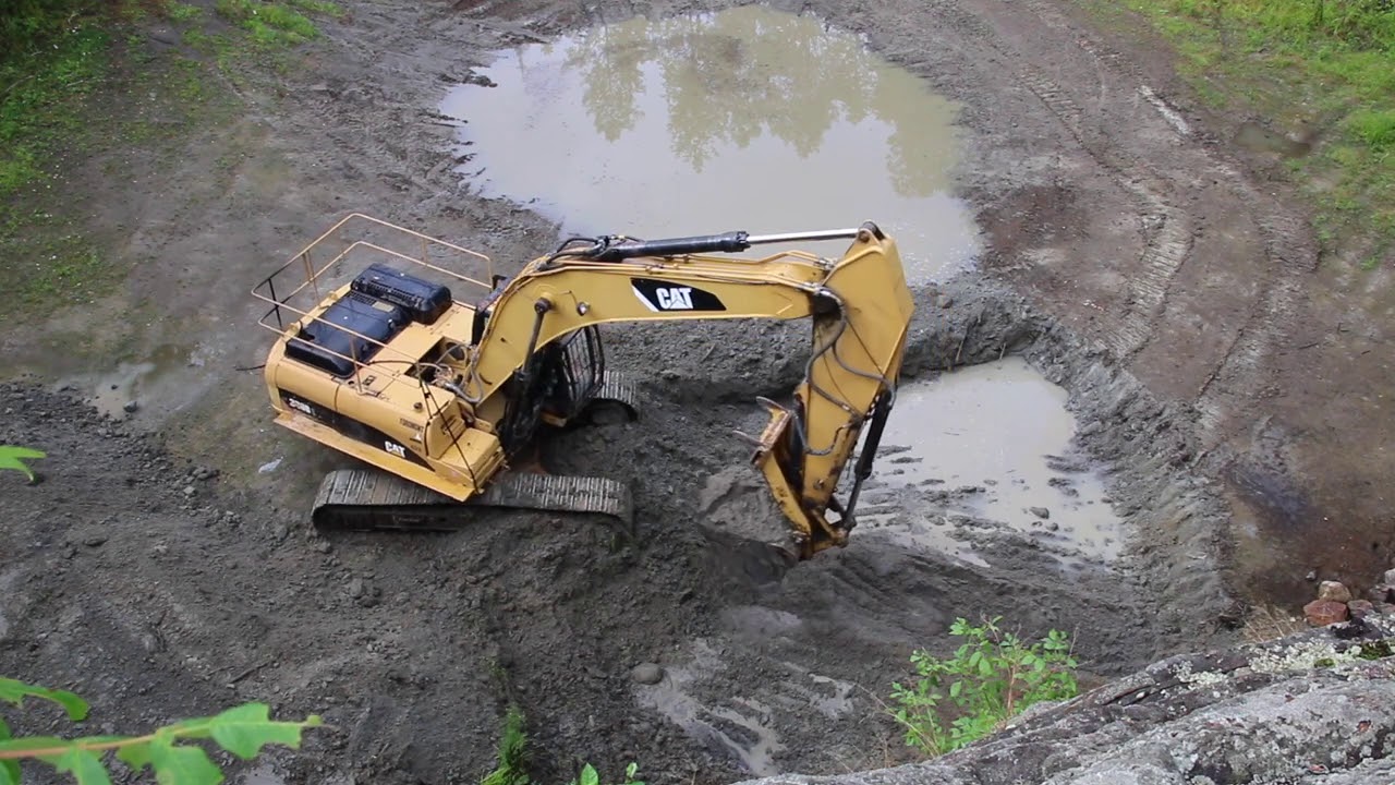 Excavator performing pond excavation and desilting work in Kansas City.